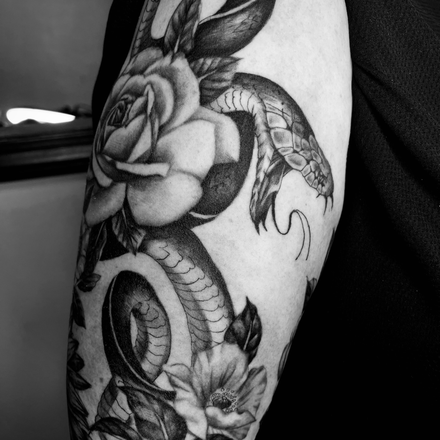 Snake and rose realism tattoo on the forearm by Sydney Rose