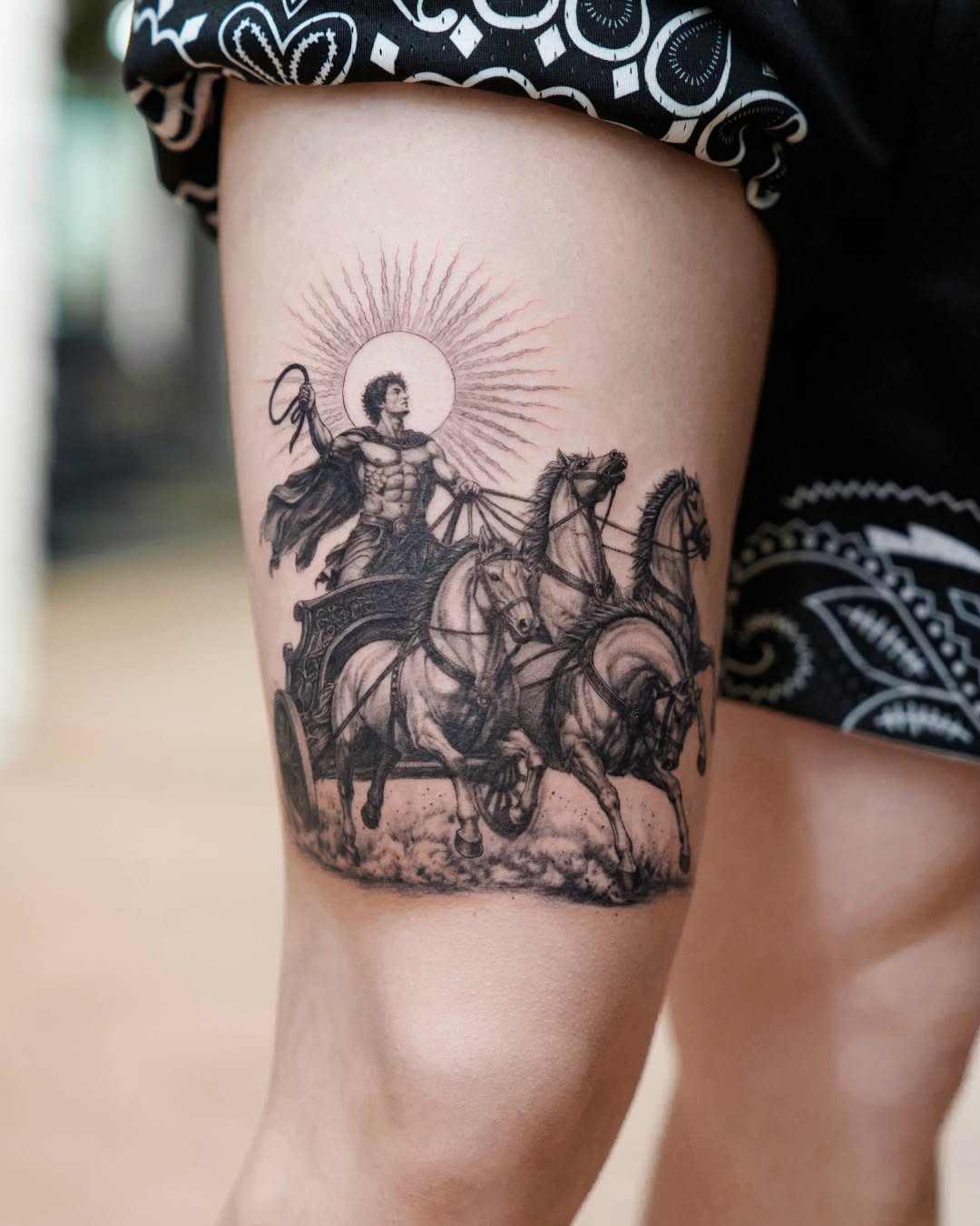 Chariot and sun realism tattoo on the thigh by Gen Li