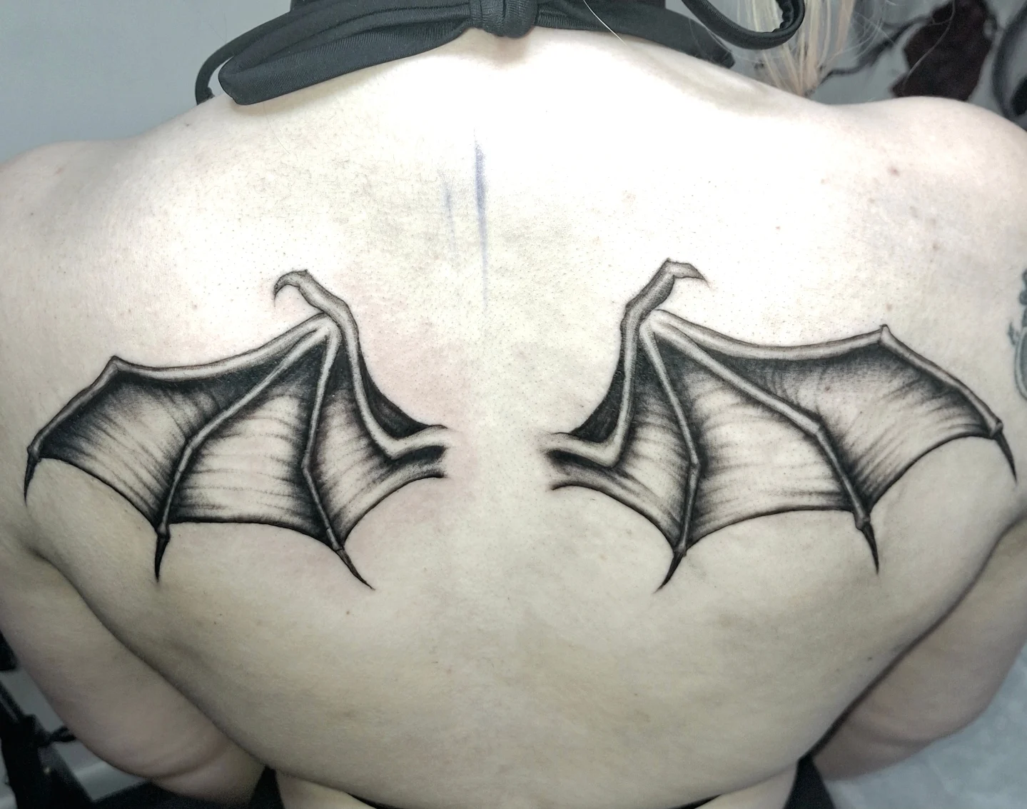 Bat wings black and grey tattoo on the back by hallowed girl tattoo