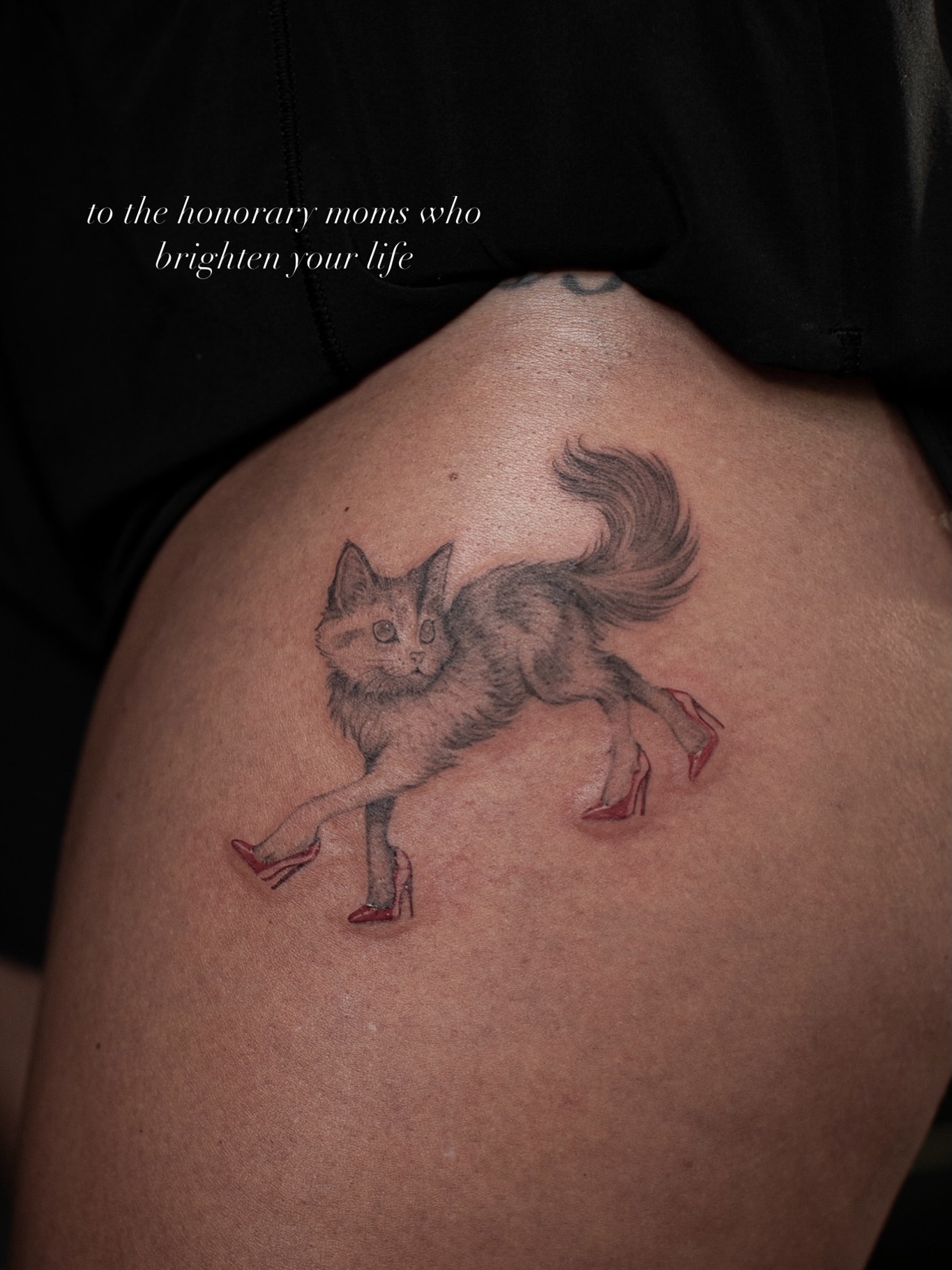 Cat wearing high heels realism tattoo on the shoulder by Aries Rising