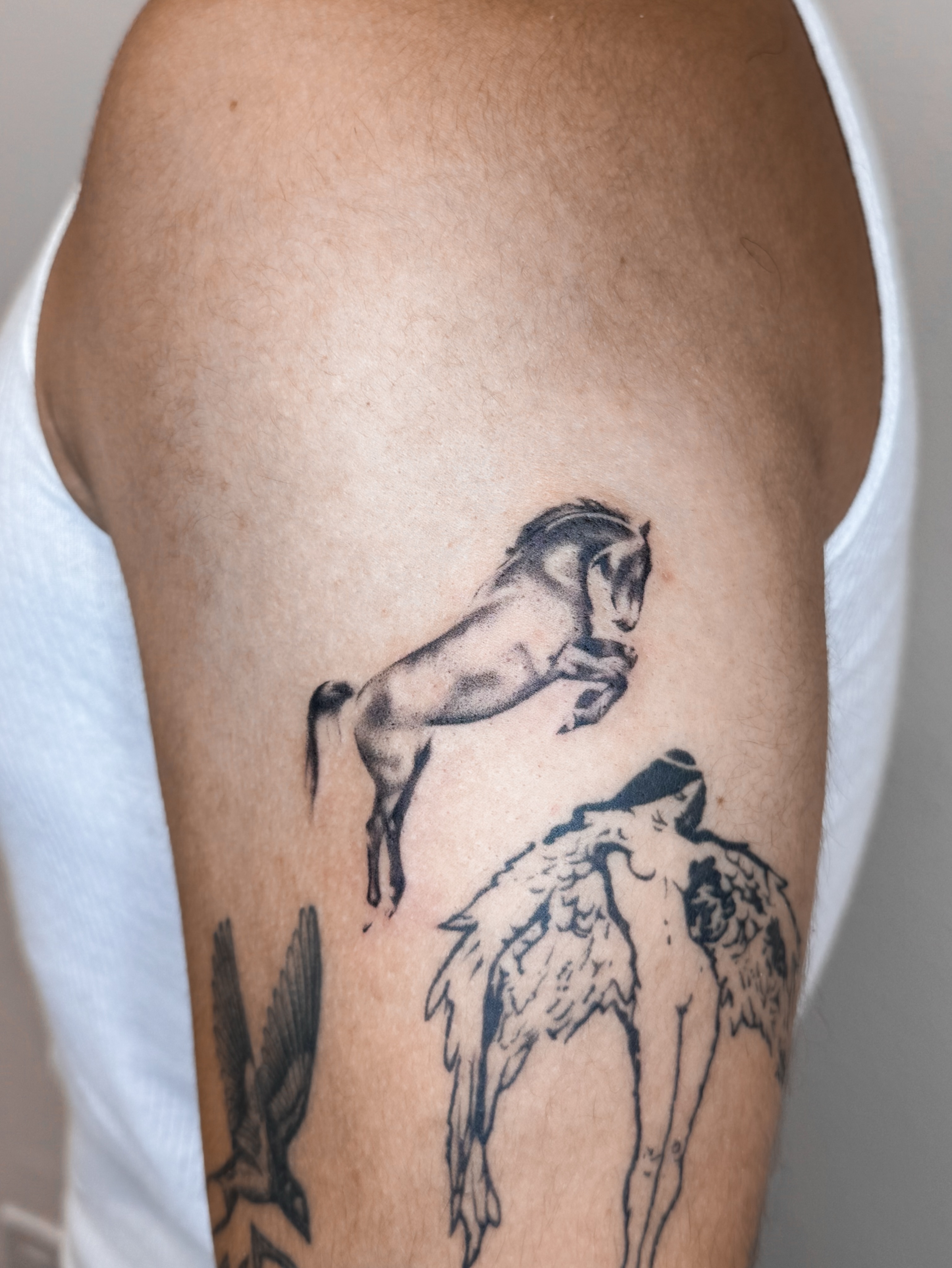 Horse and angel black and grey tattoo on the forearm by Rylee