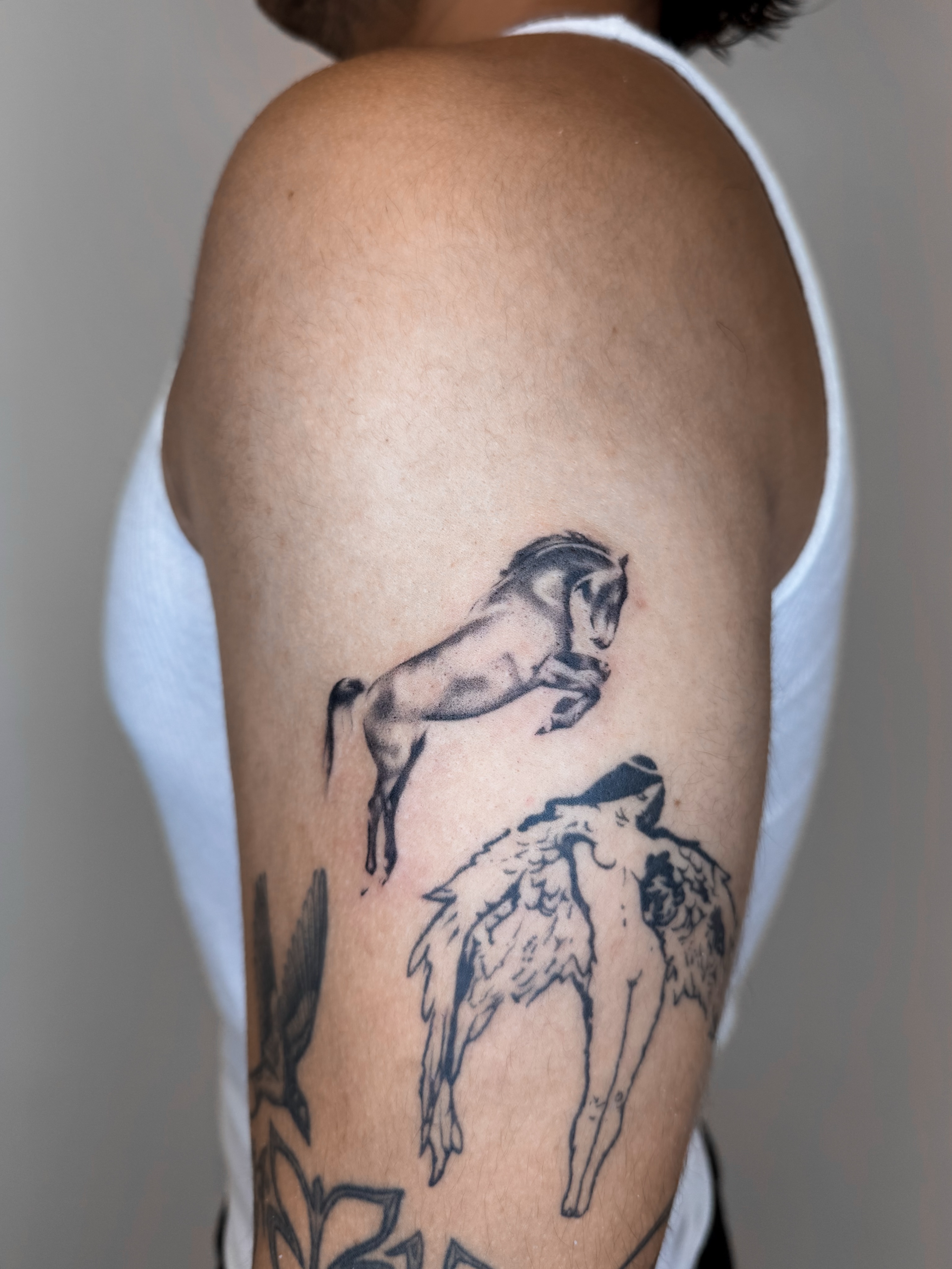 Horse and angel realism tattoo on the forearm by Rylee