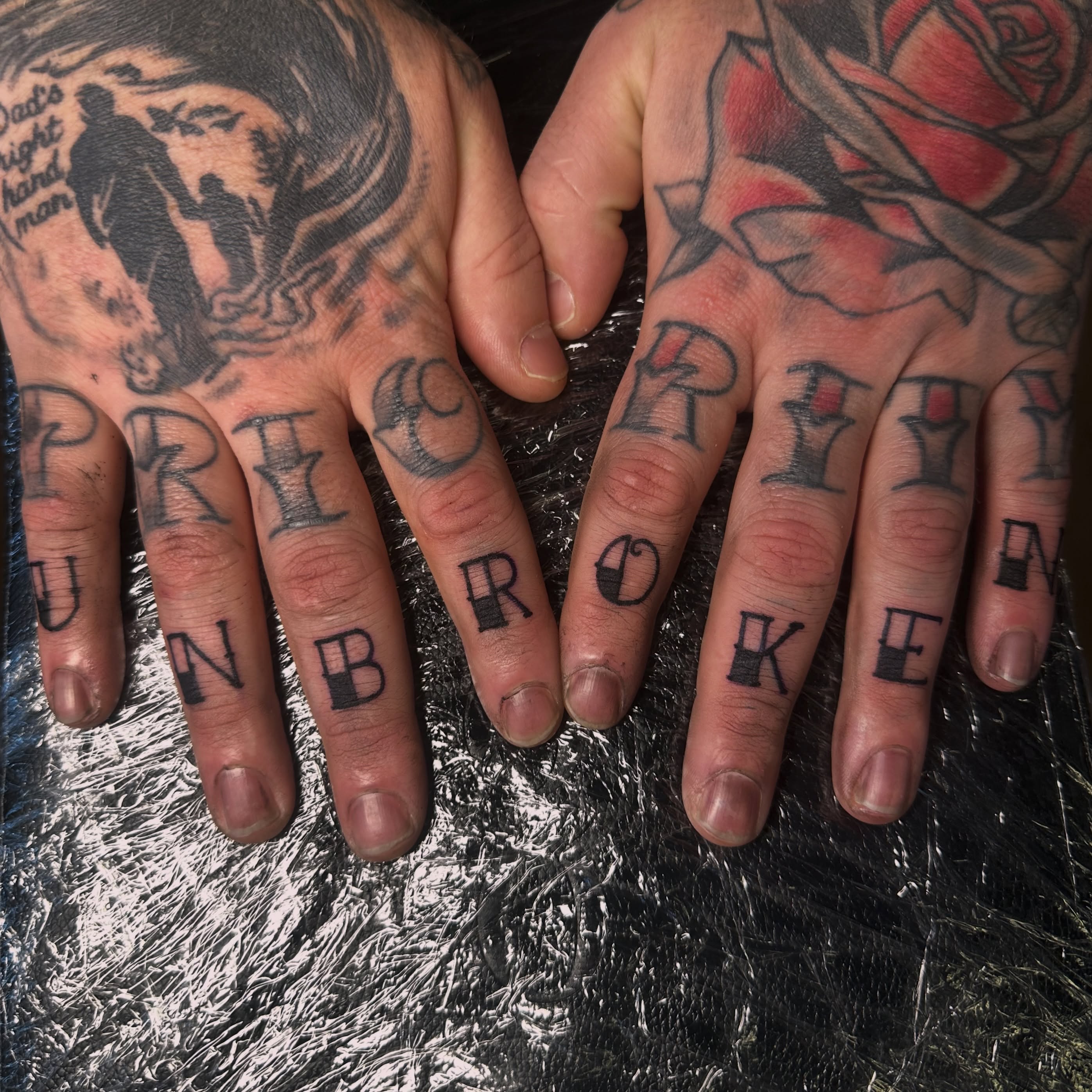 Broken black and grey tattoo on the hand by Drew’s Tattoos (NH)