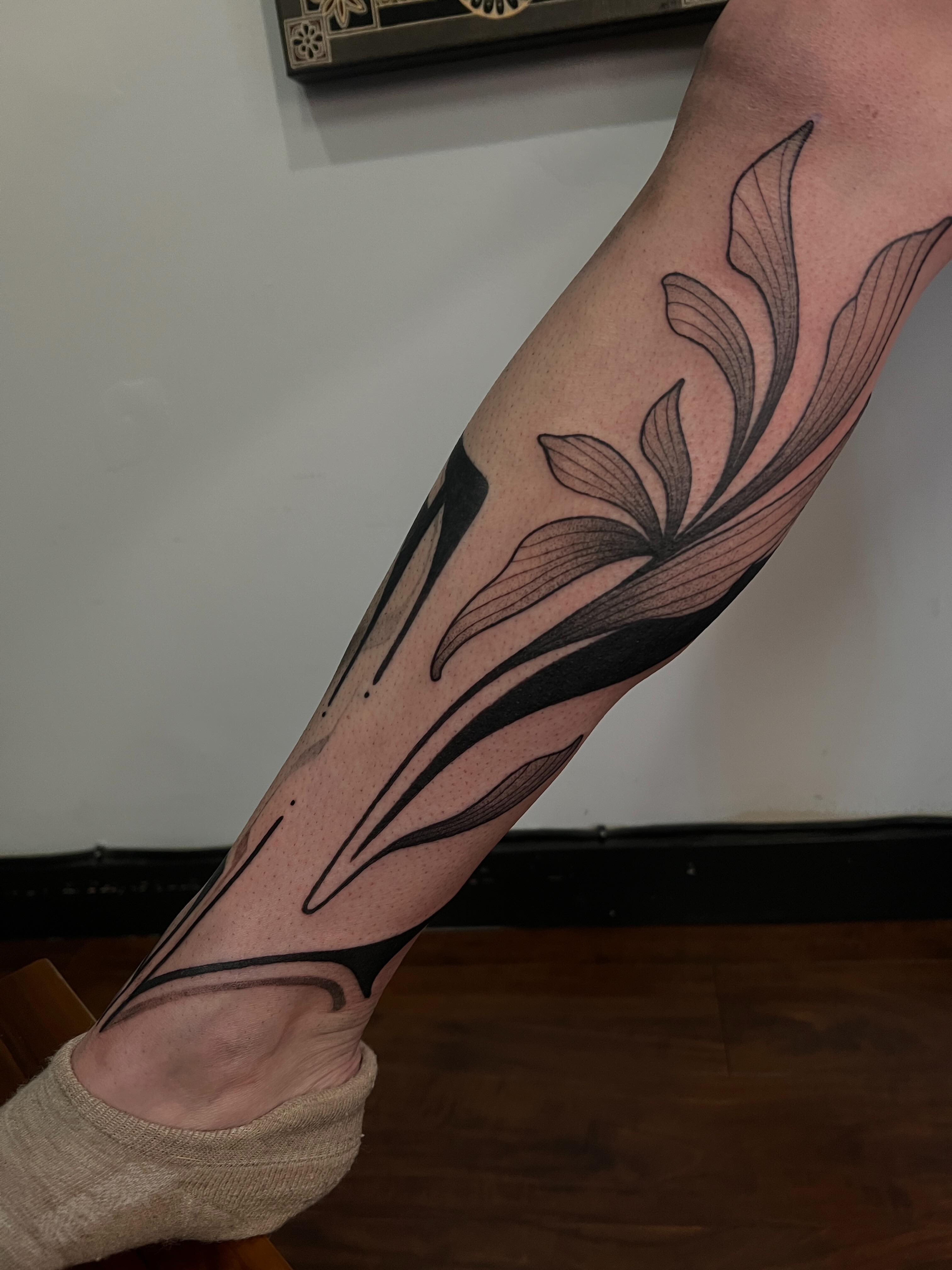 Lily black and grey tattoo on the forearm by Avrey Simone