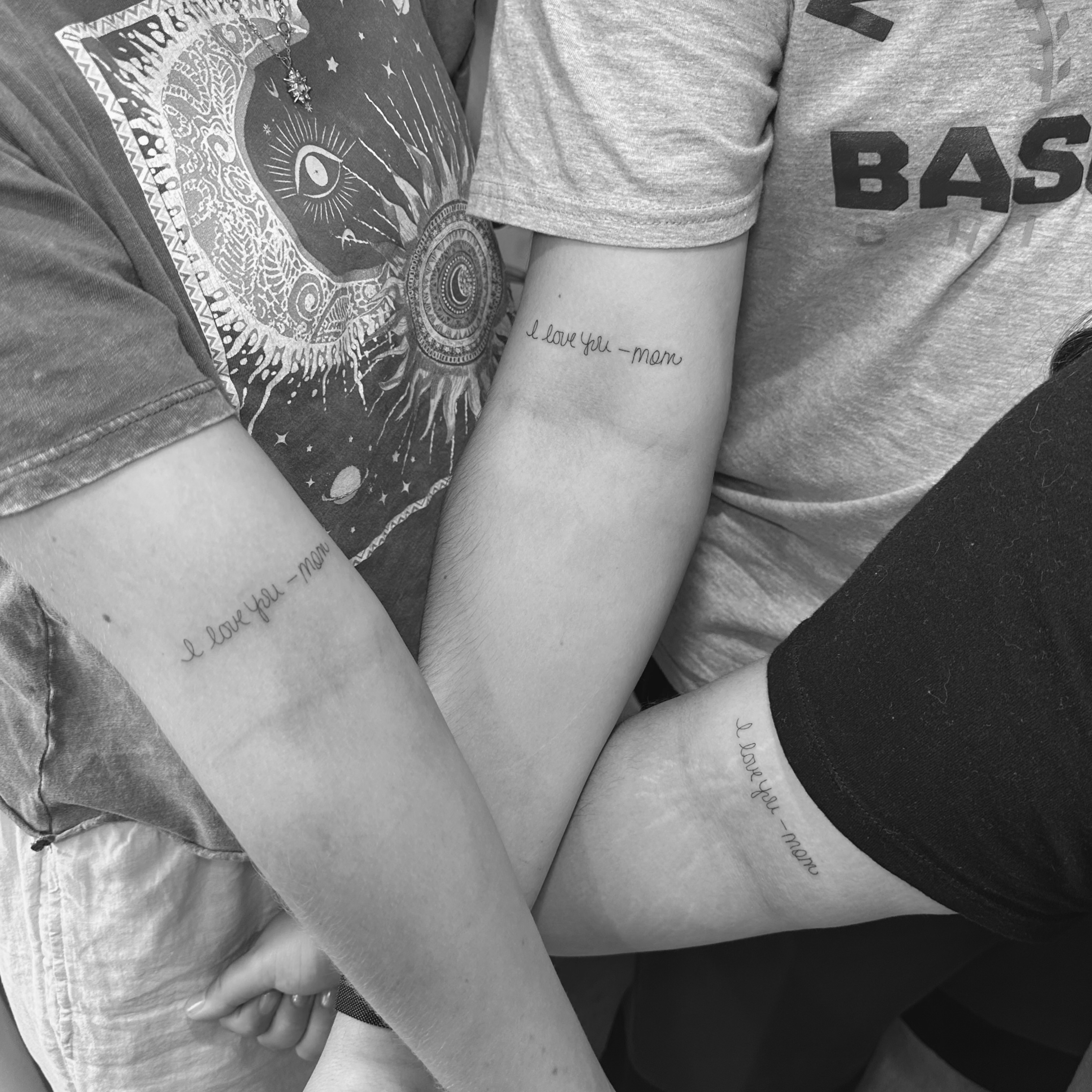 I love you—man lettering script tattoo on the forearm by Jessica, Cheektowaga, New York