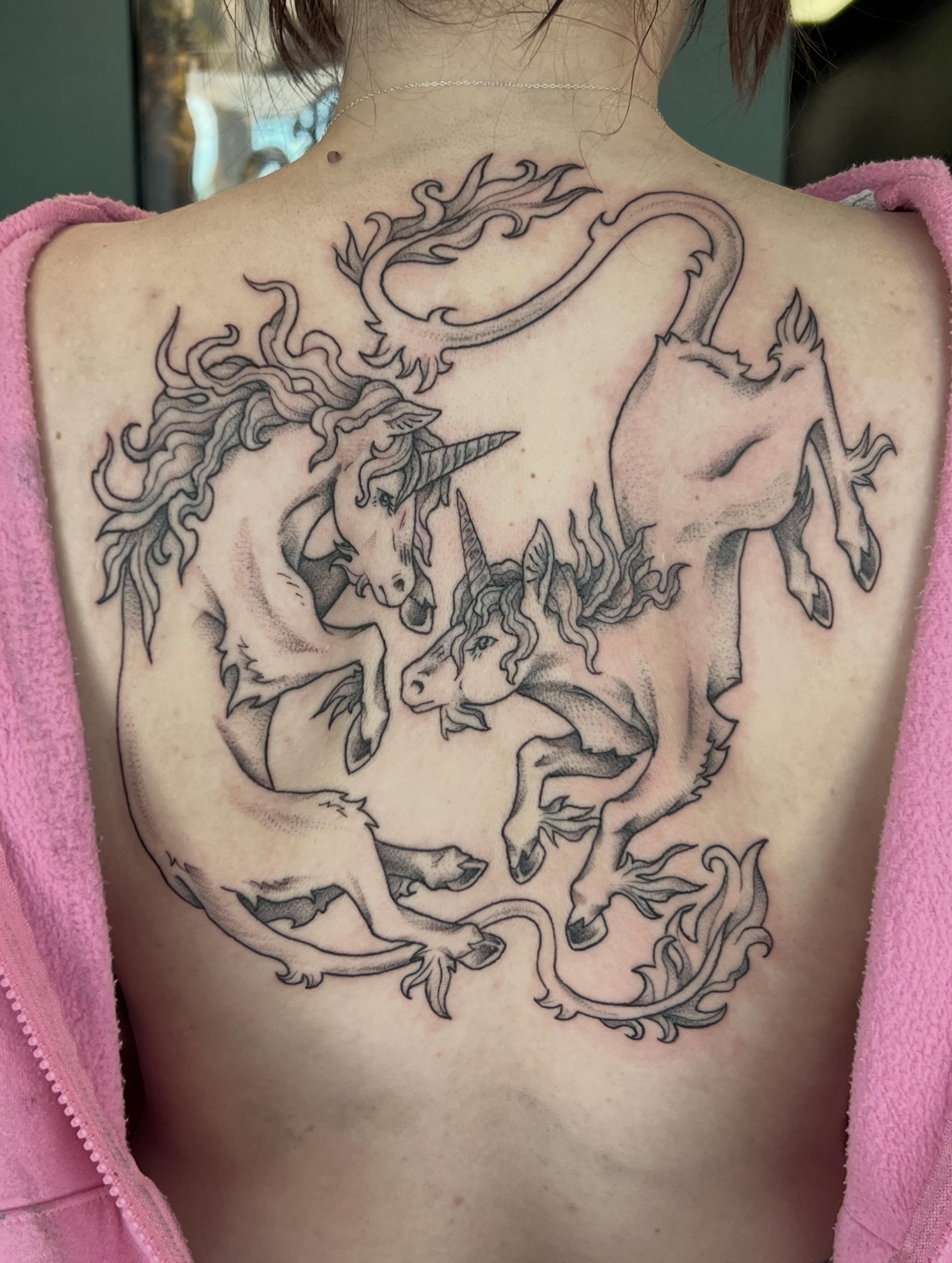 Unicorns black and grey tattoo on the back by Callie πͺ
