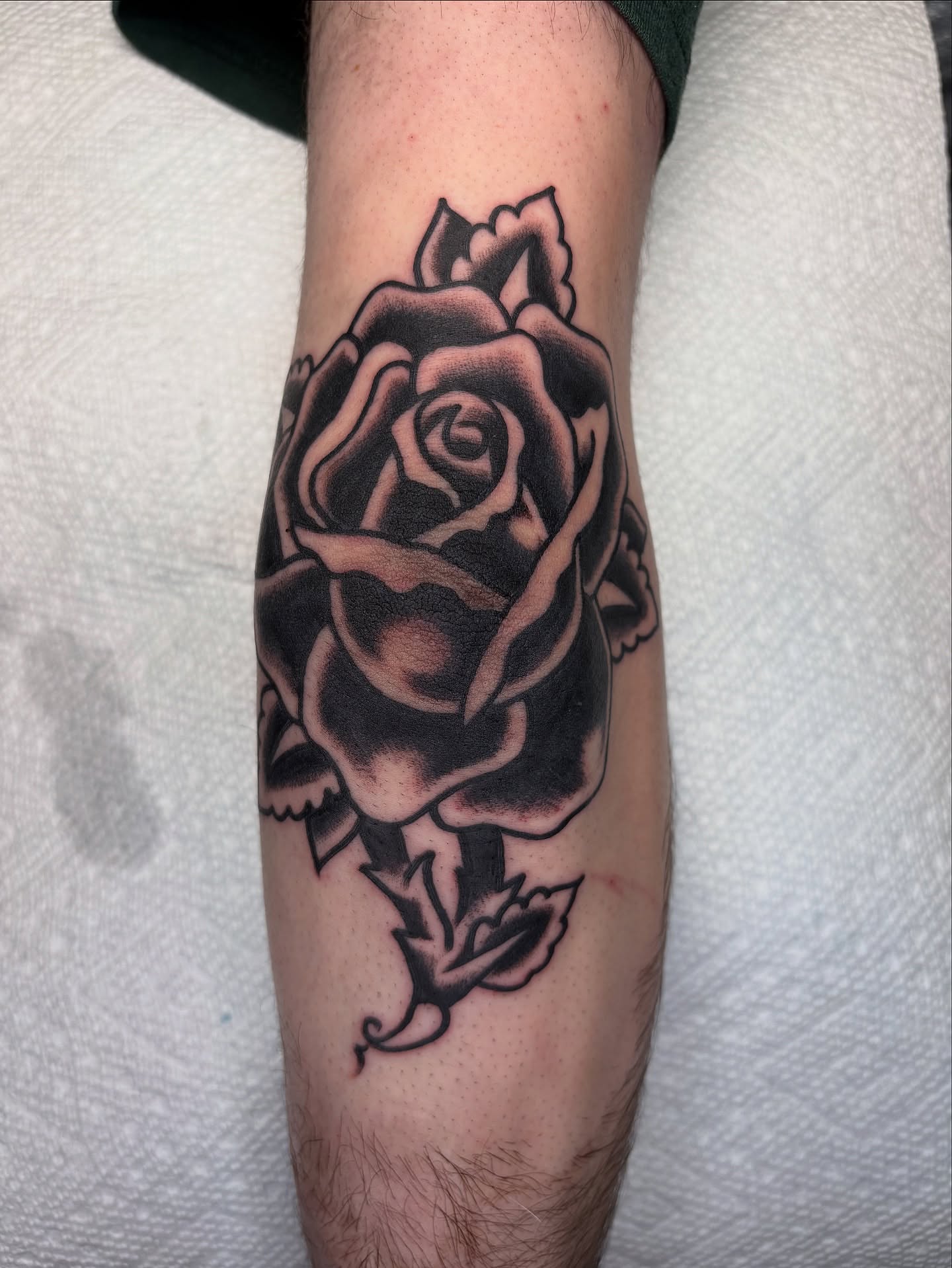 Rose black and grey tattoo on the forearm by Andrew Silva