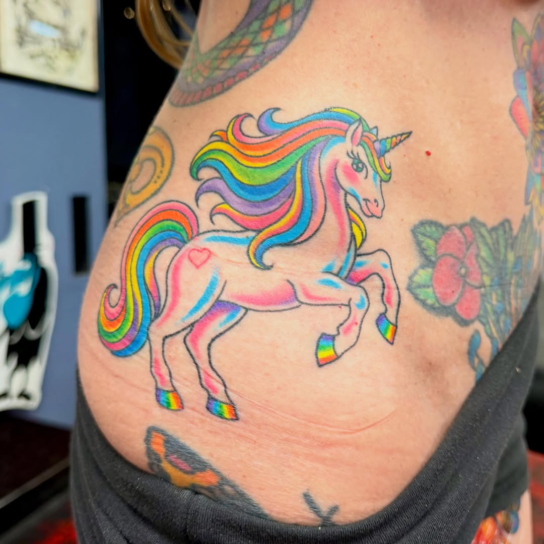 Rainbow unicorn new school tattoo on the thigh by Max mogstad