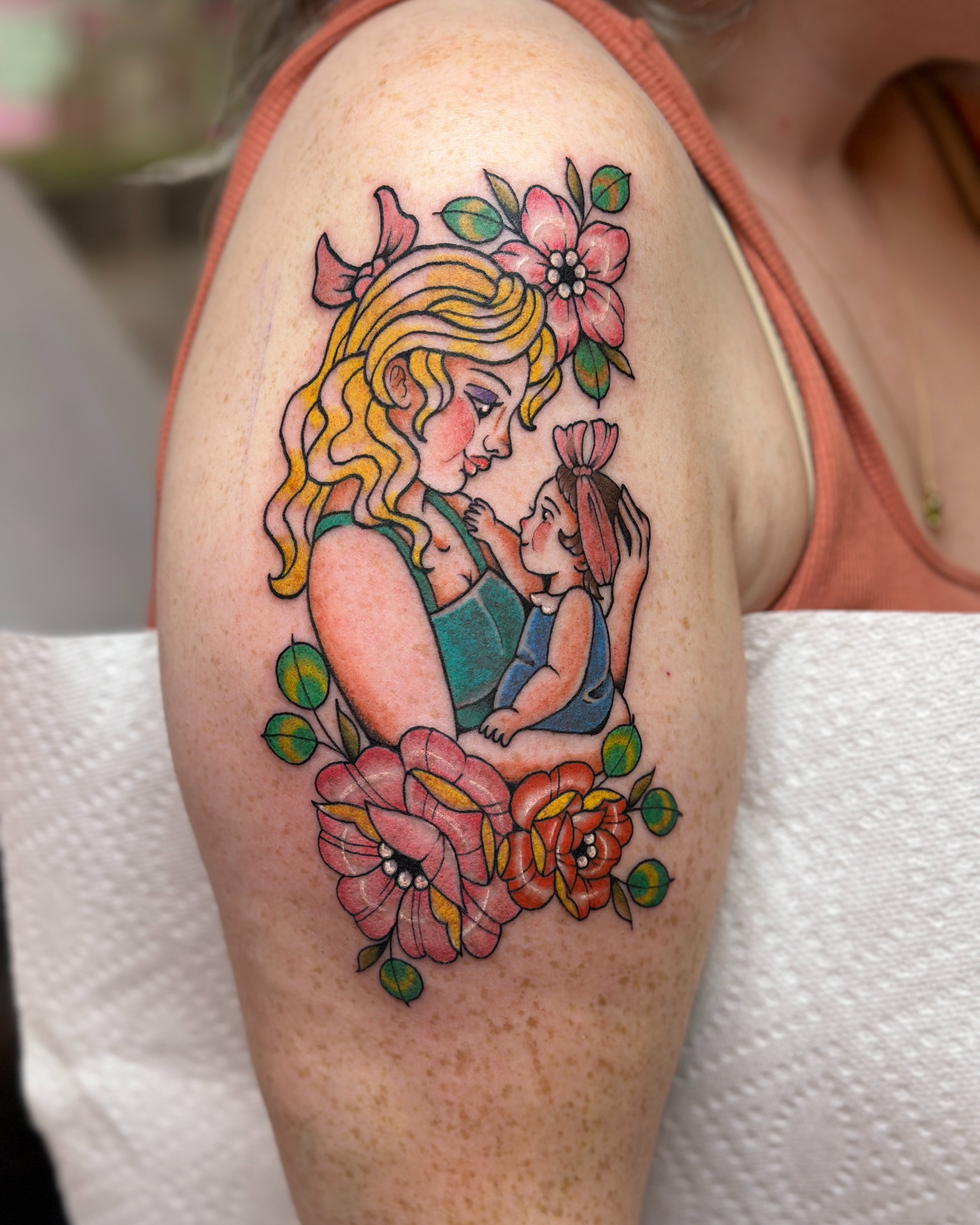 Mother and child new school tattoo on the shoulder by Dani Di Pietrantonio