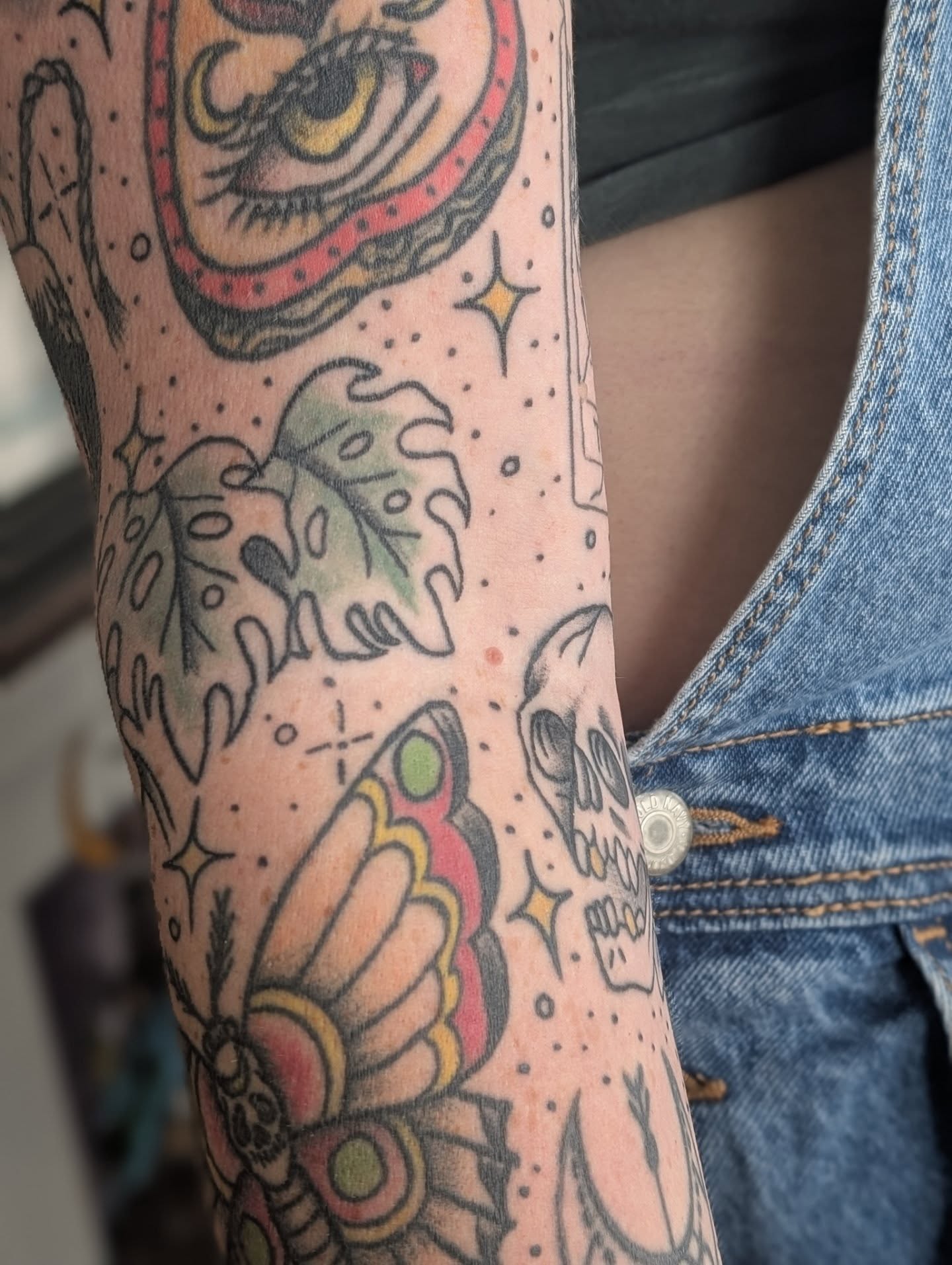 Tiger and plant American traditional tattoo on the forearm by Alexandria Green