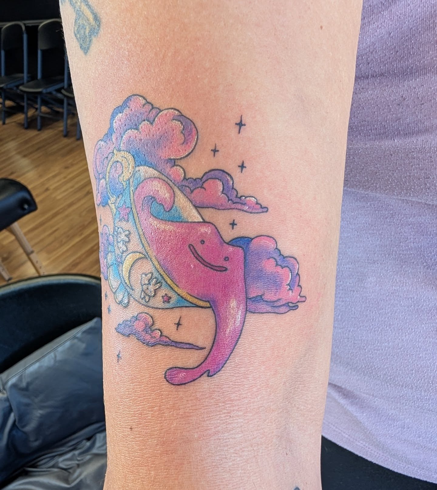 Whale and clouds new school tattoo on the forearm by Chad Nuber
