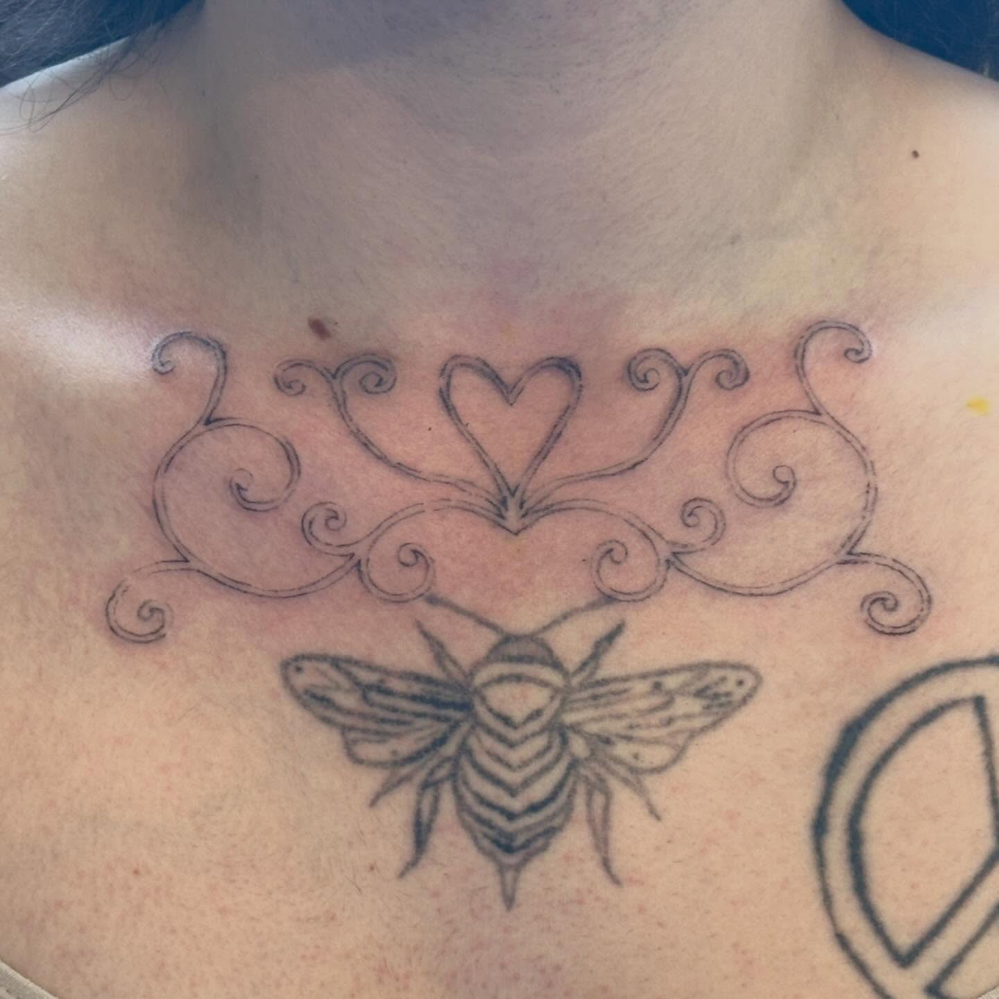Bee and heart black and grey tattoo on the chest by Jules🕯️