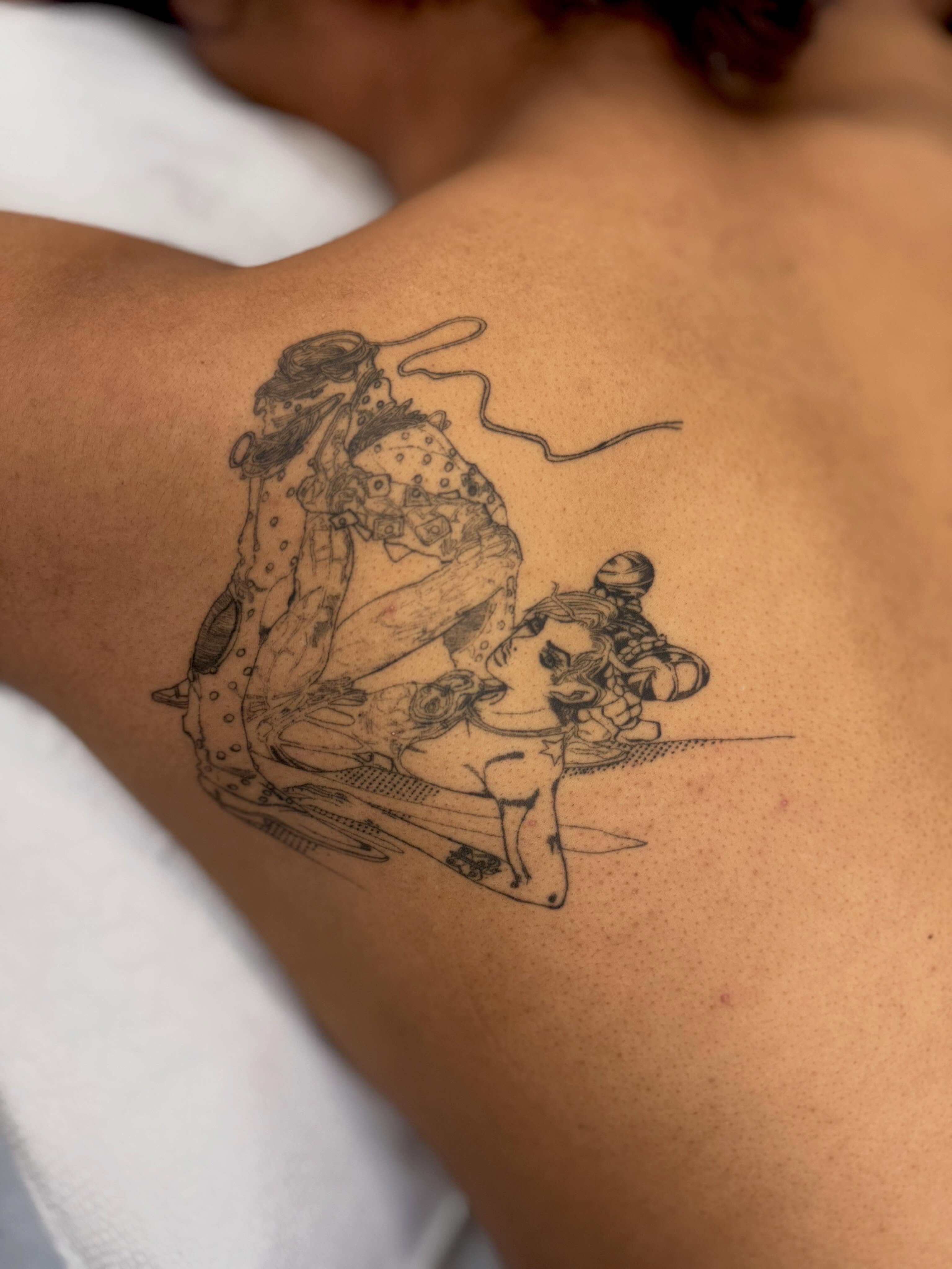 Anime characters anime tattoo on the back by Em Krieg
