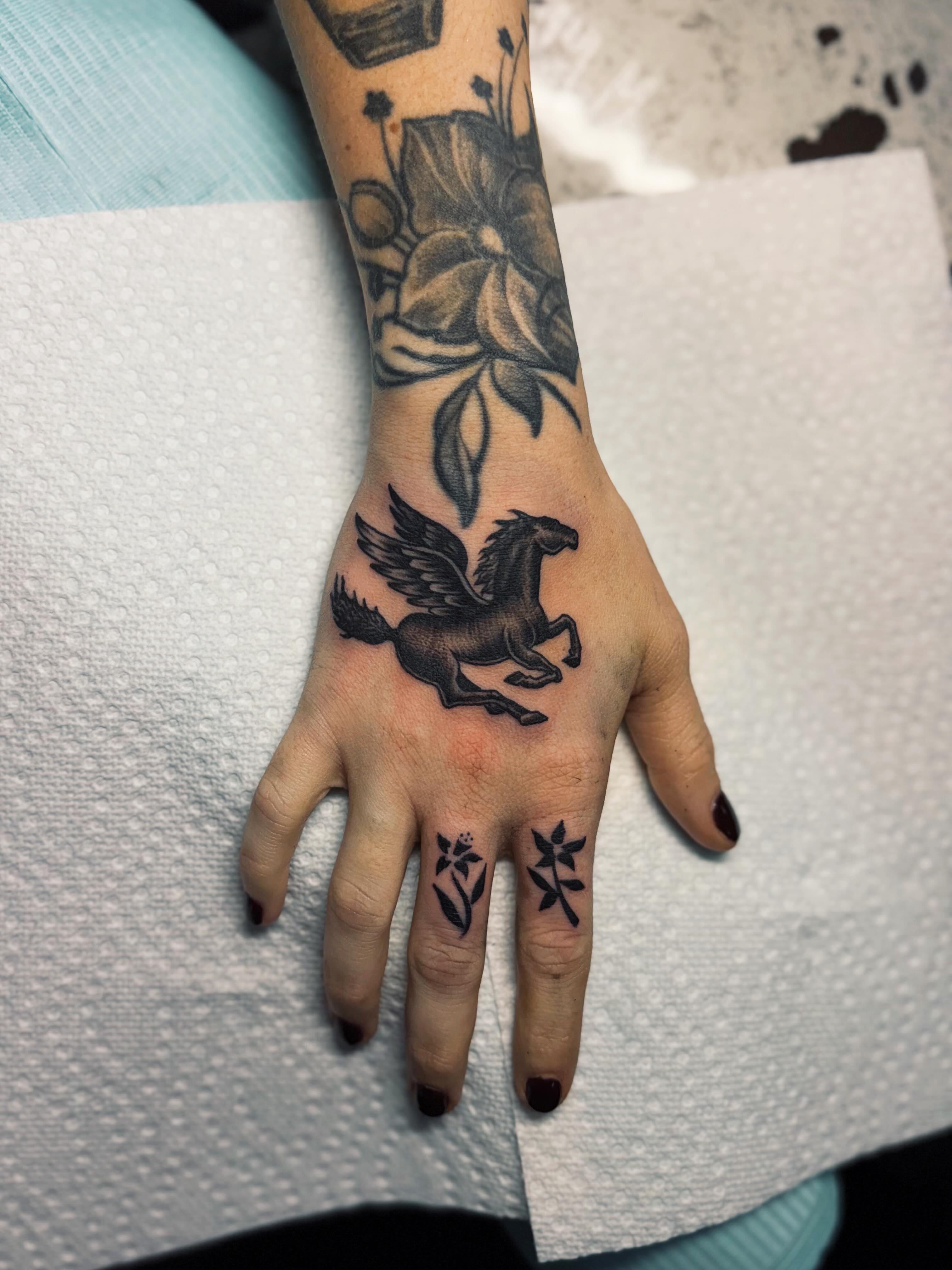 Pegasus black and grey tattoo on the hand by @amandahowtattoo