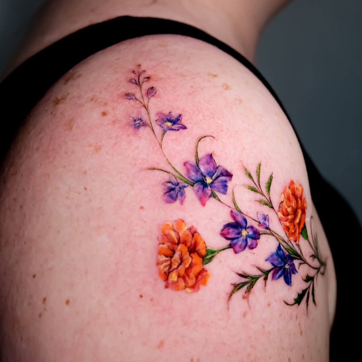 Floral arrangement watercolor tattoo on the shoulder by NAS