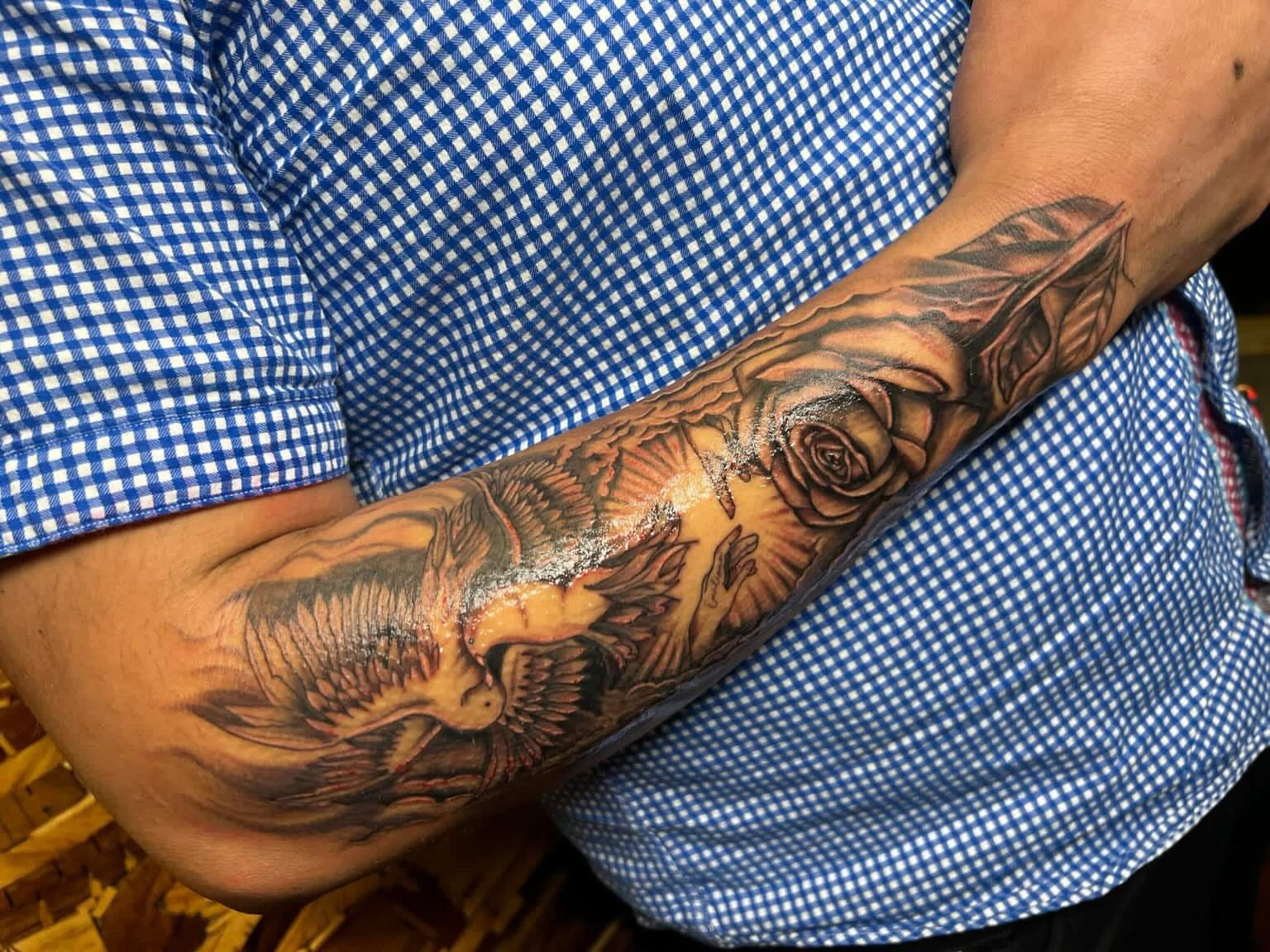 Eagle and roses realism tattoo on the forearm by Tattoomobile