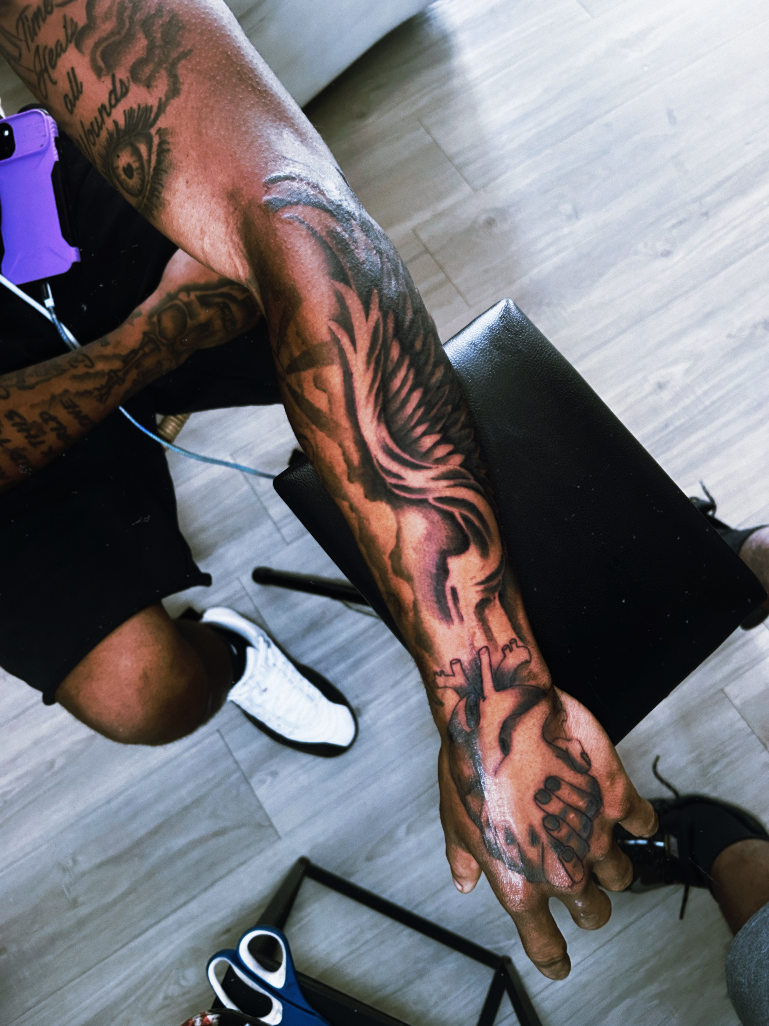 Winged hand black and grey tattoo on the forearm by Tito Cross ❤️‍🔥