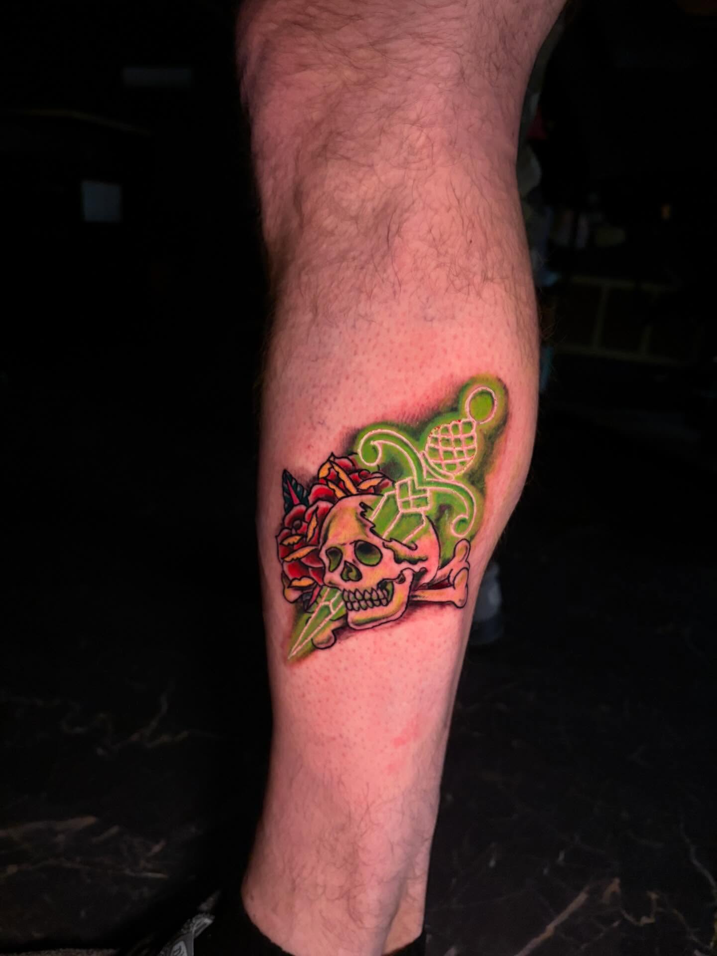 Skull and rose American traditional tattoo on the forearm by Fredrick Tigerman