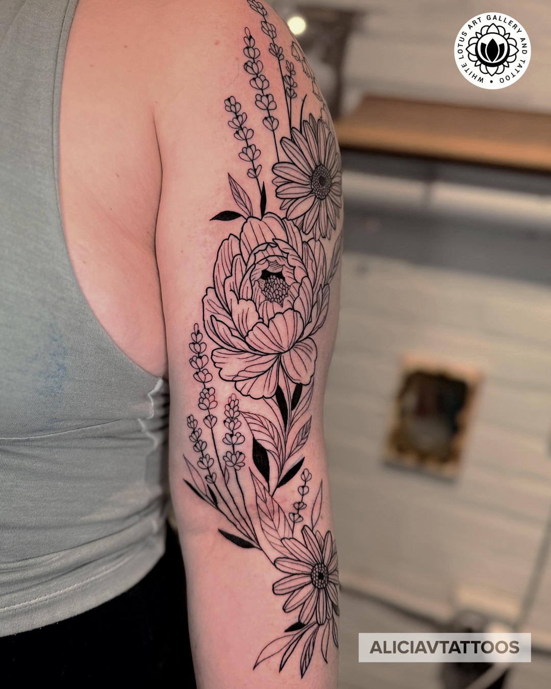 Floral bouquet black and grey tattoo on the forearm by Alicia Vasquez