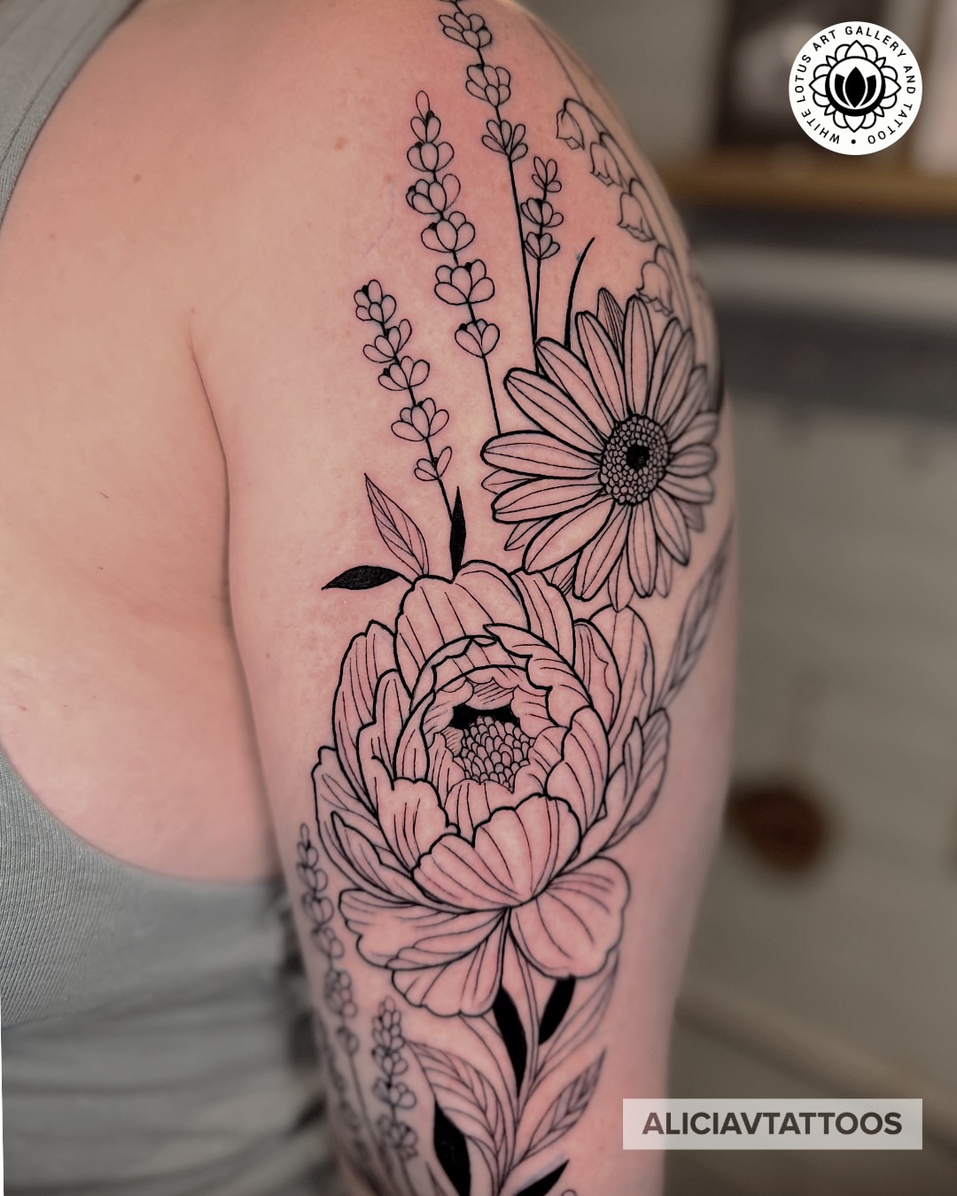 Floral arrangement realism tattoo on the shoulder by Alicia Vasquez