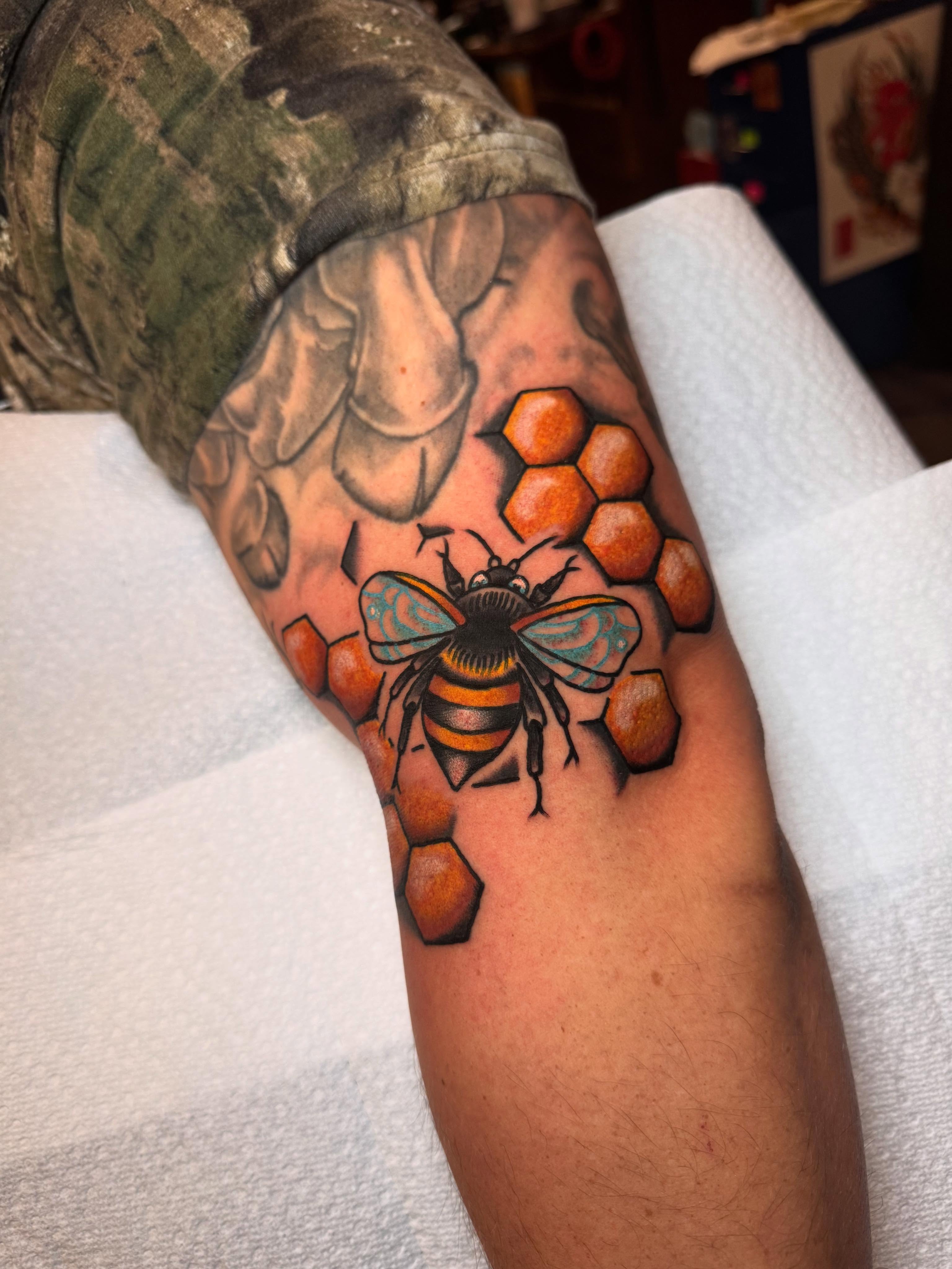 Bee and honeycomb realism tattoo on the forearm by Jonathan Clapp, San Antonio, Texas