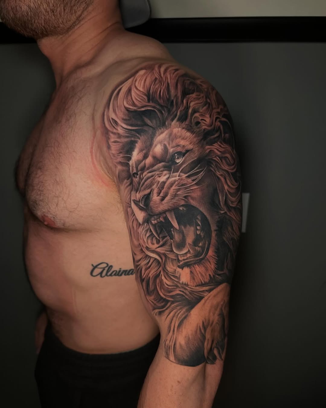 Roaring lion head realism tattoo on the shoulder by T, Saugus, Massachusetts