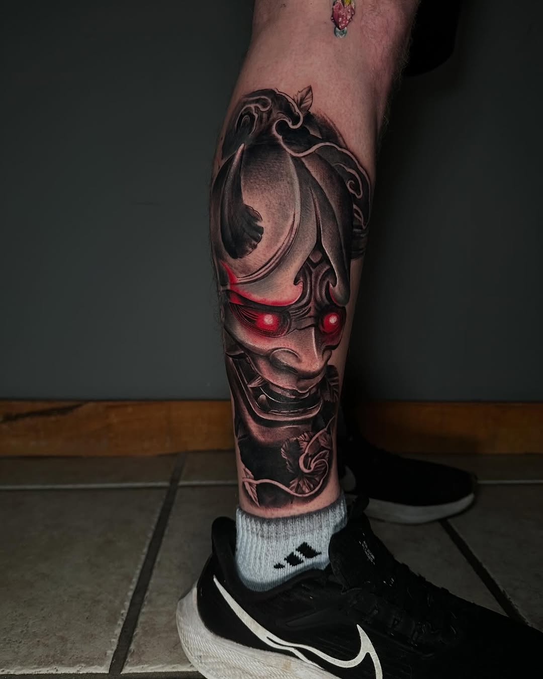Oni mask Japanese tattoo on the calf by T, Saugus, Massachusetts