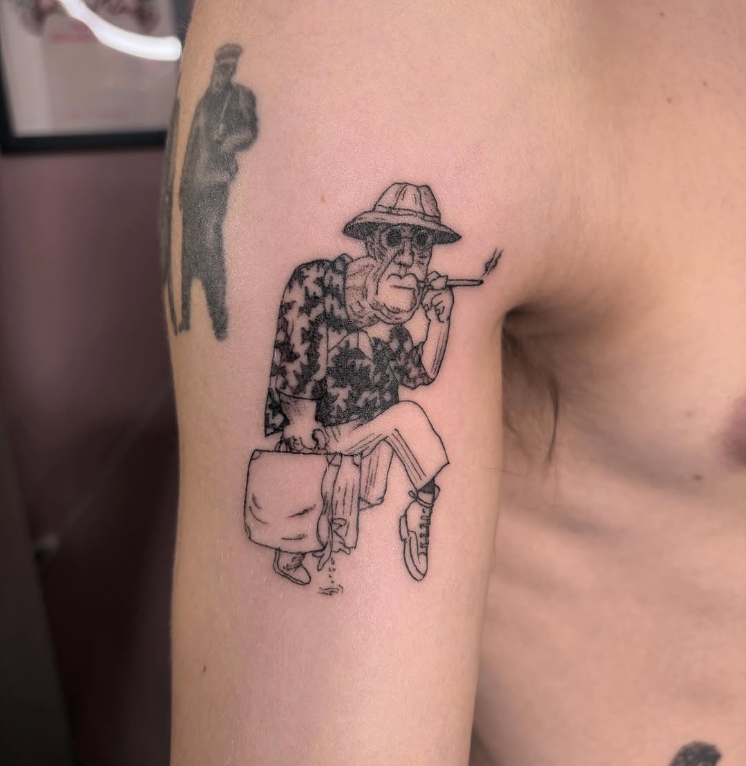 Elderly man smoking black and grey tattoo on the upper arm by Mary Hannah Sosdian