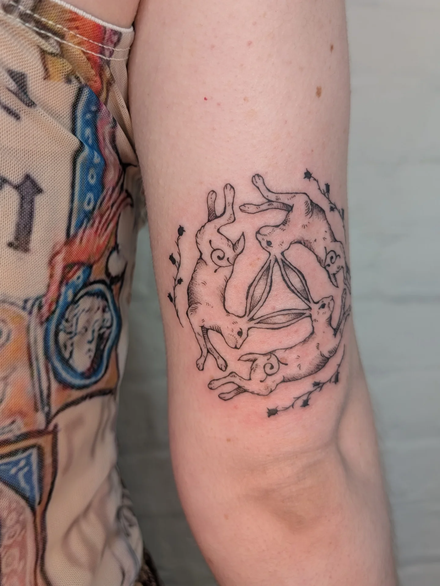 Rabbits black and grey tattoo on the forearm by mila