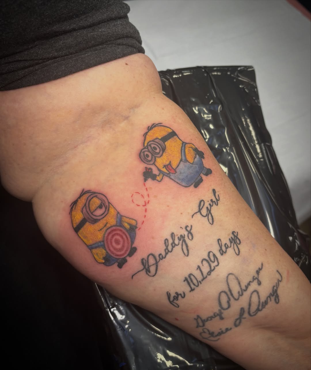 Minions dotwork tattoo on the forearm by Anastasia Carrasco