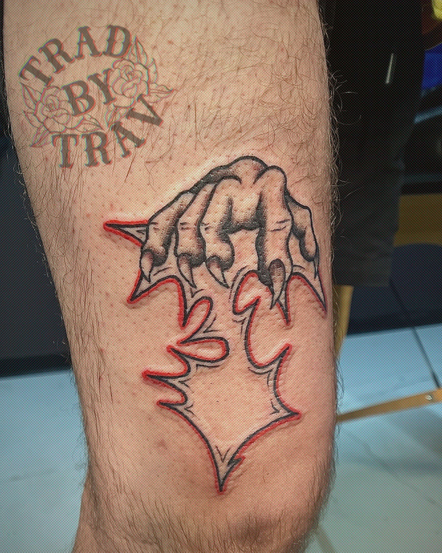 Clawed hand with flame American traditional tattoo on the forearm by Travis B