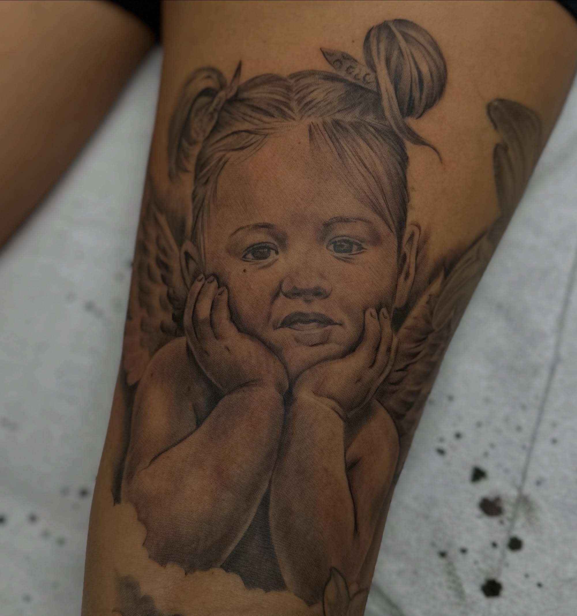Child angel realism tattoo on the forearm by Matthew Doherty