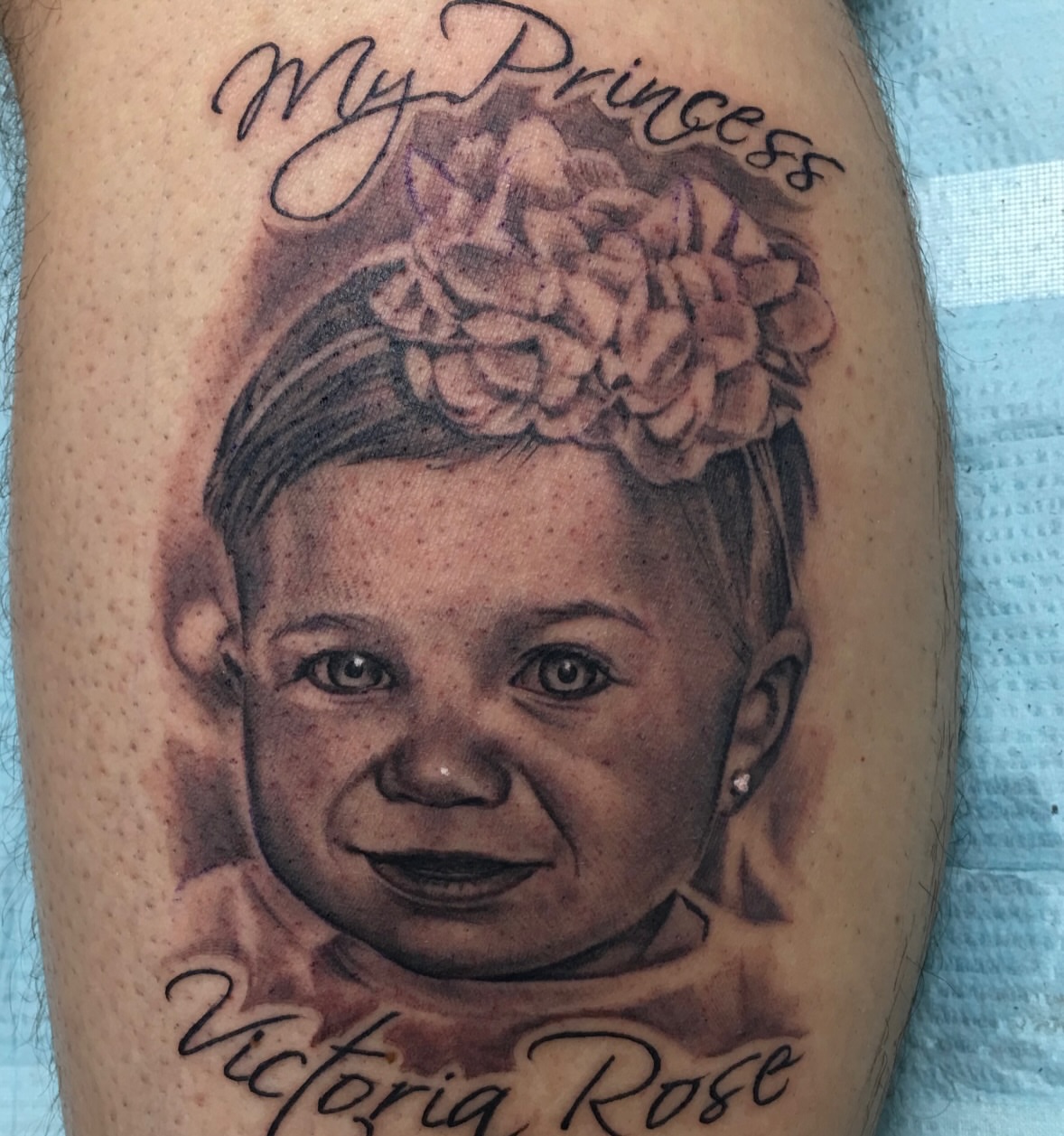 Child portrait realism tattoo on the forearm by Matthew Doherty