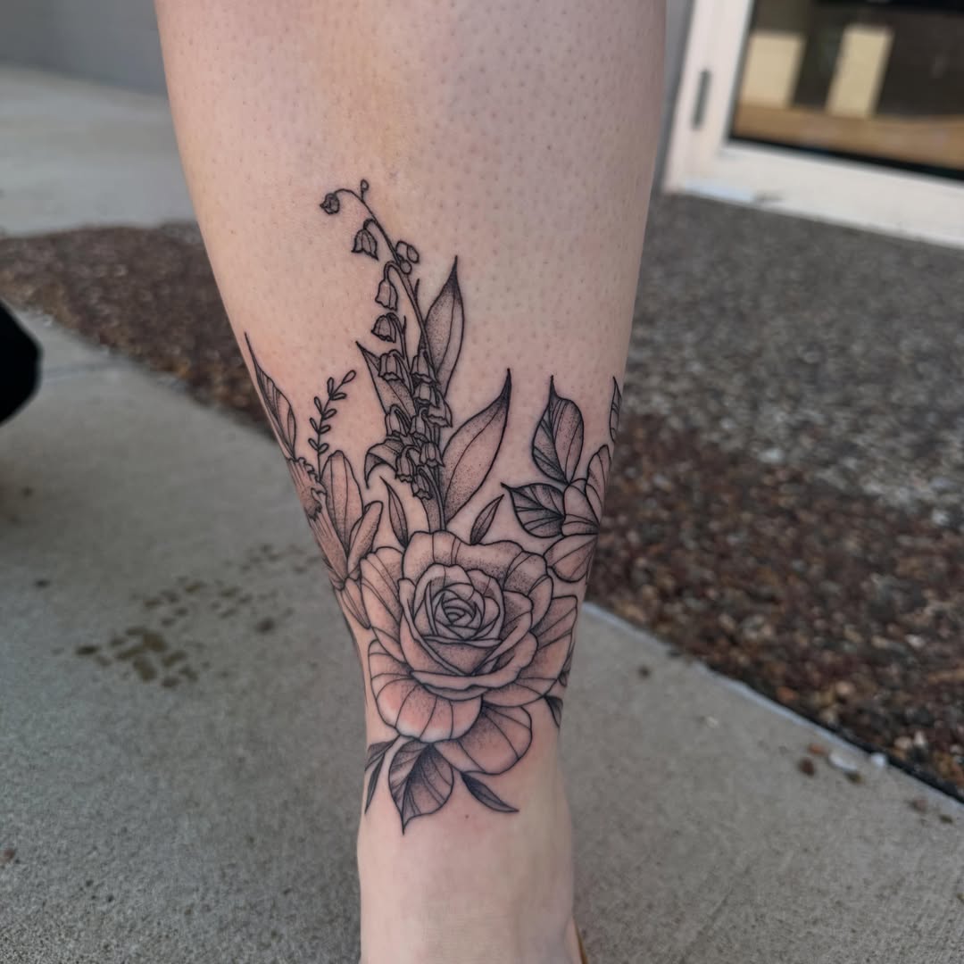 Floral arrangement black and grey tattoo on the forearm by Erica Rose π€