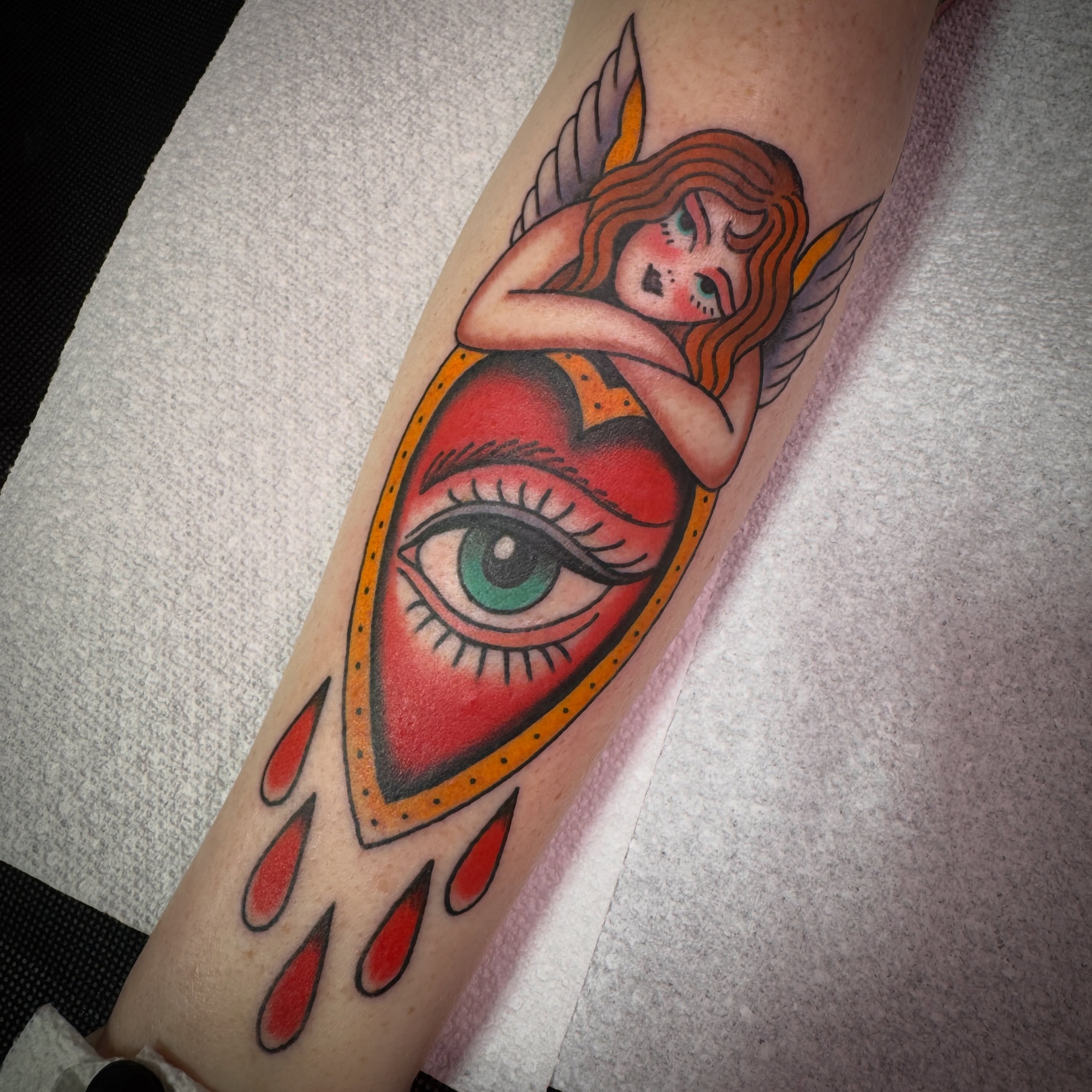 Eye with angel American traditional tattoo on the forearm by Tannis - Traditional Tattoos in Richmond, VA, Richmond, Virginia