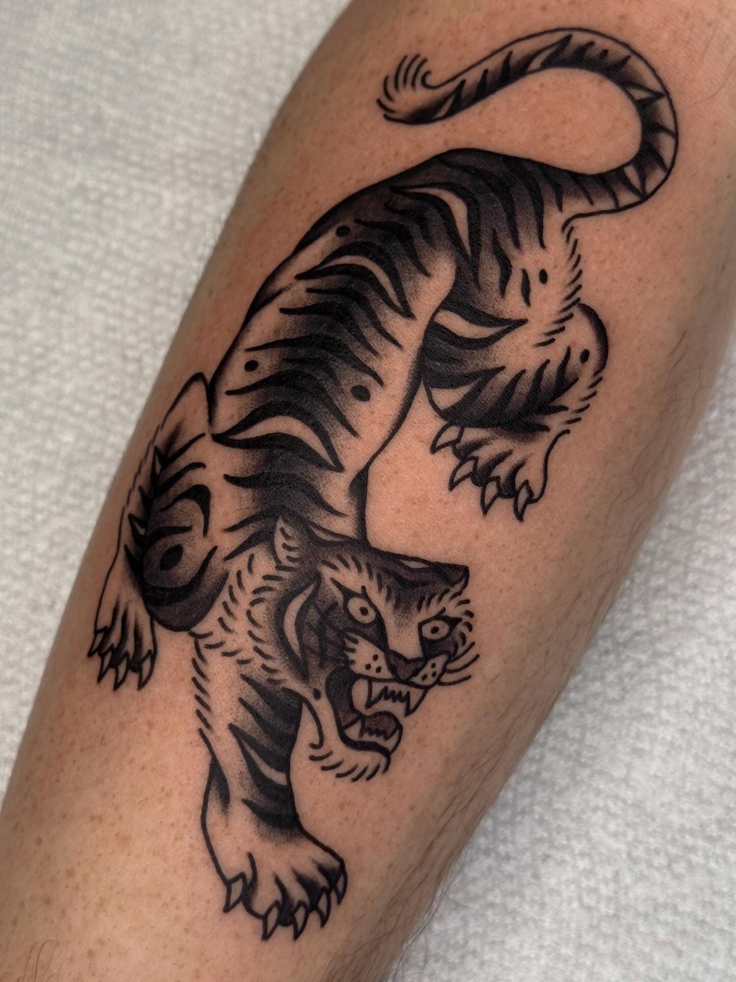 Tiger American traditional tattoo on the forearm by Bridgette Carberry