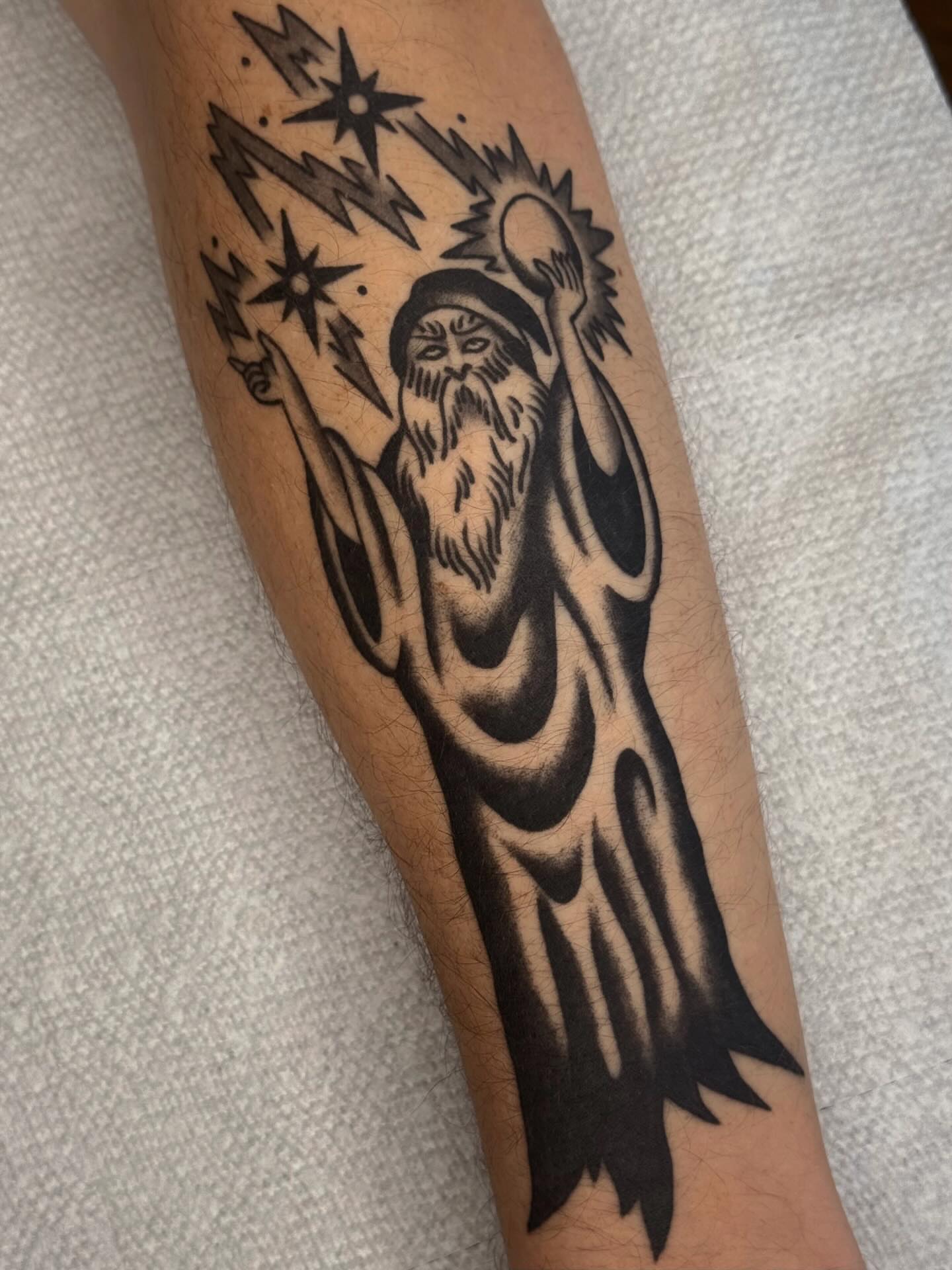Wizard black and grey tattoo on the forearm by Bridgette Carberry