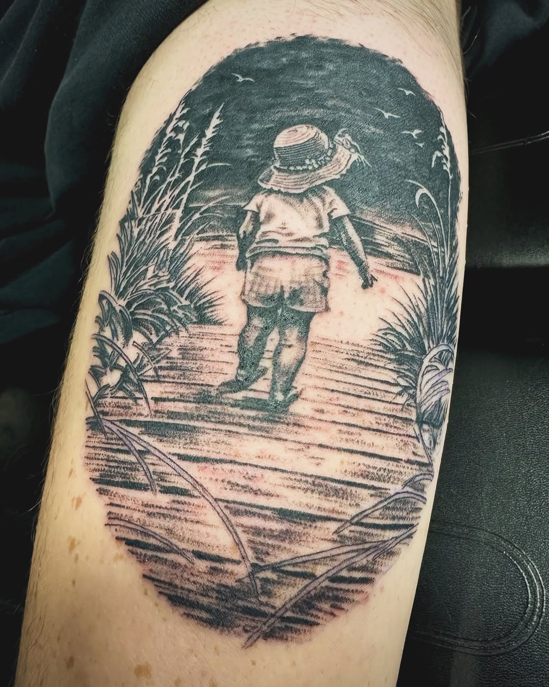 Child walking on a boardwalk surrealism tattoo on the forearm by Jason Ponce