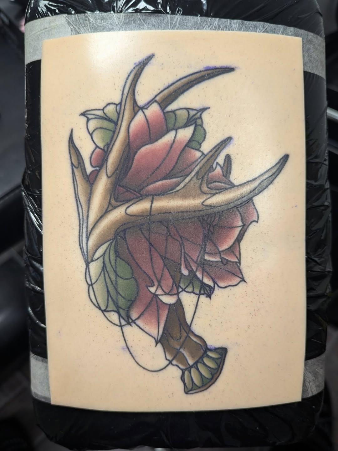 Antler and rose neo-traditional tattoo by Payton