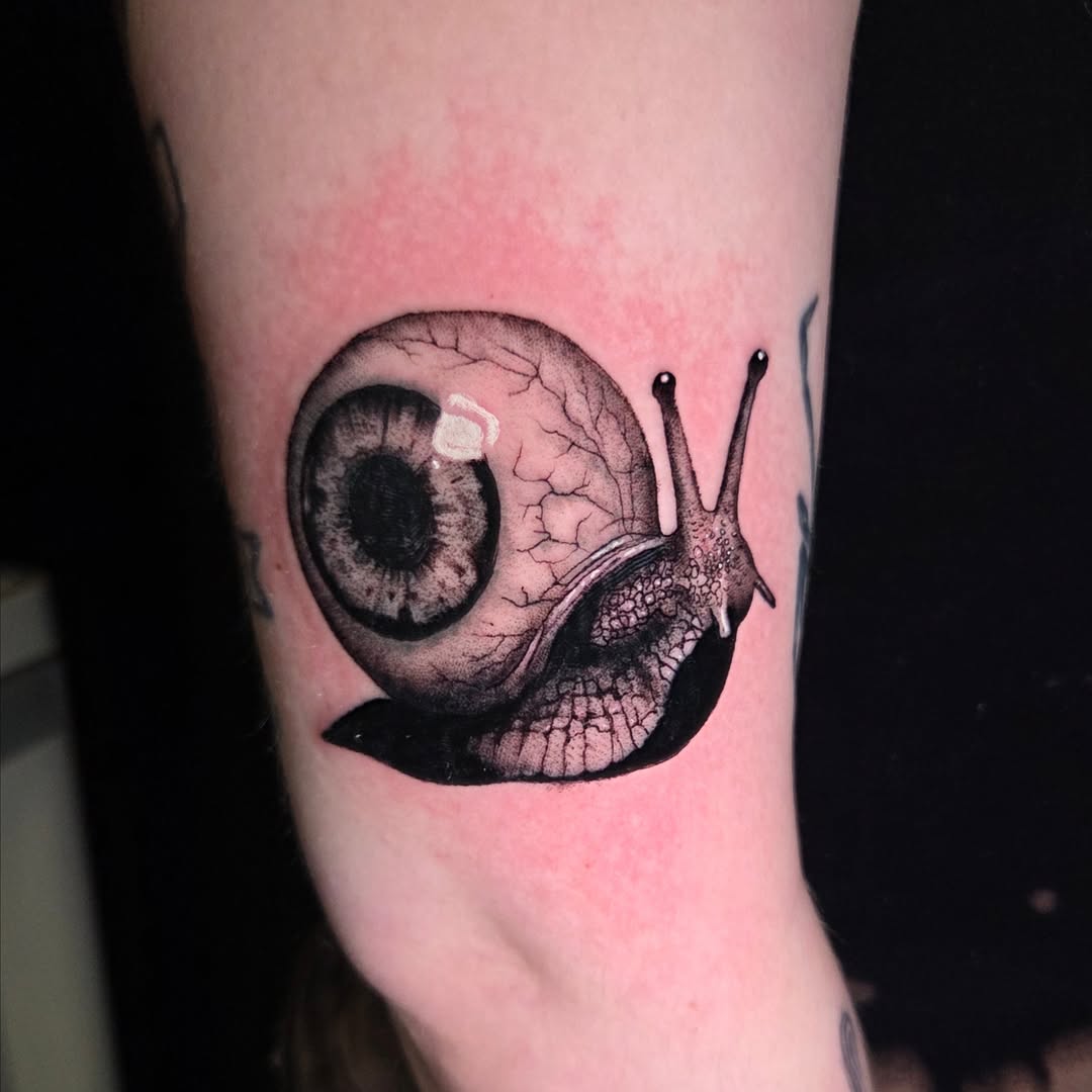 Snail realism tattoo on the forearm by Maya Neideck