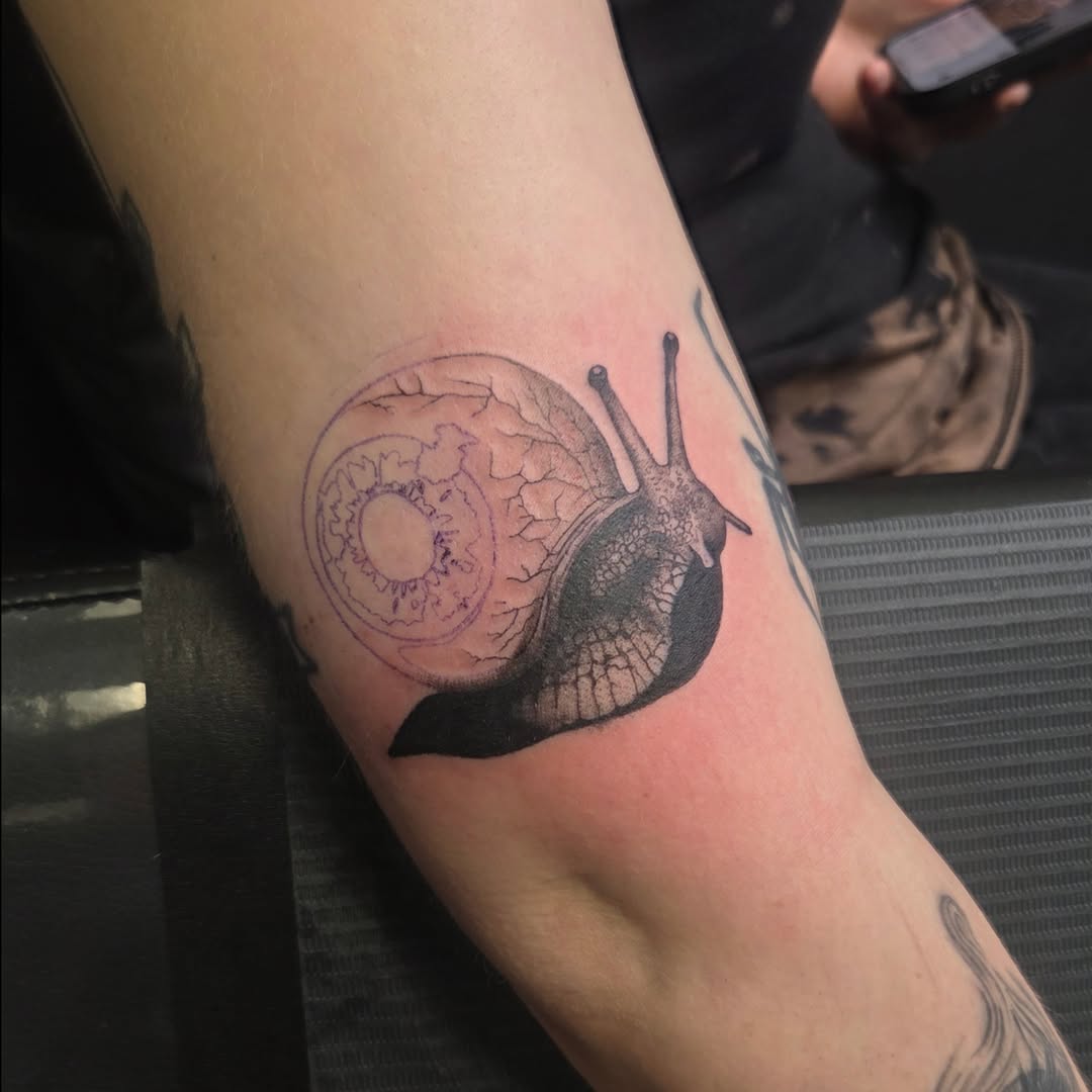 Snail realism tattoo on the forearm by Maya Neideck