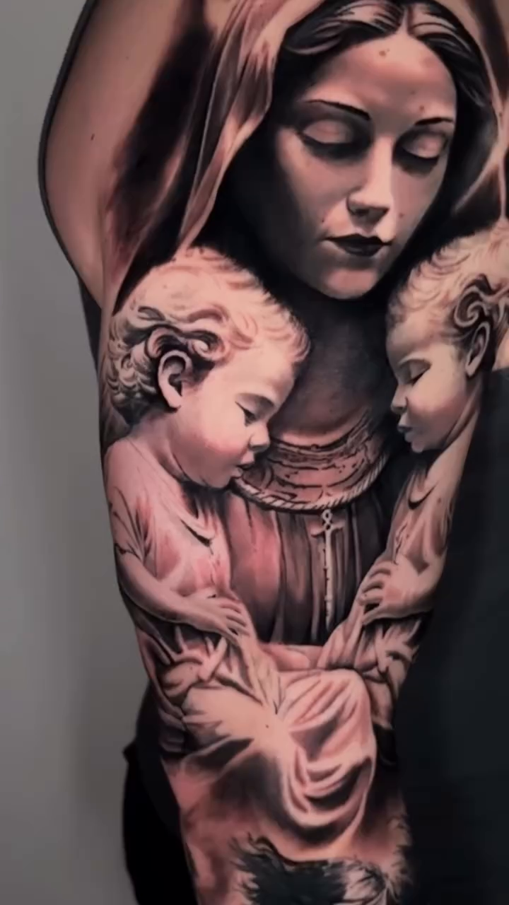 Virgin Mary and child angels sleeve Chicano tattoo on the upper arm by angel.antonio.tattoos