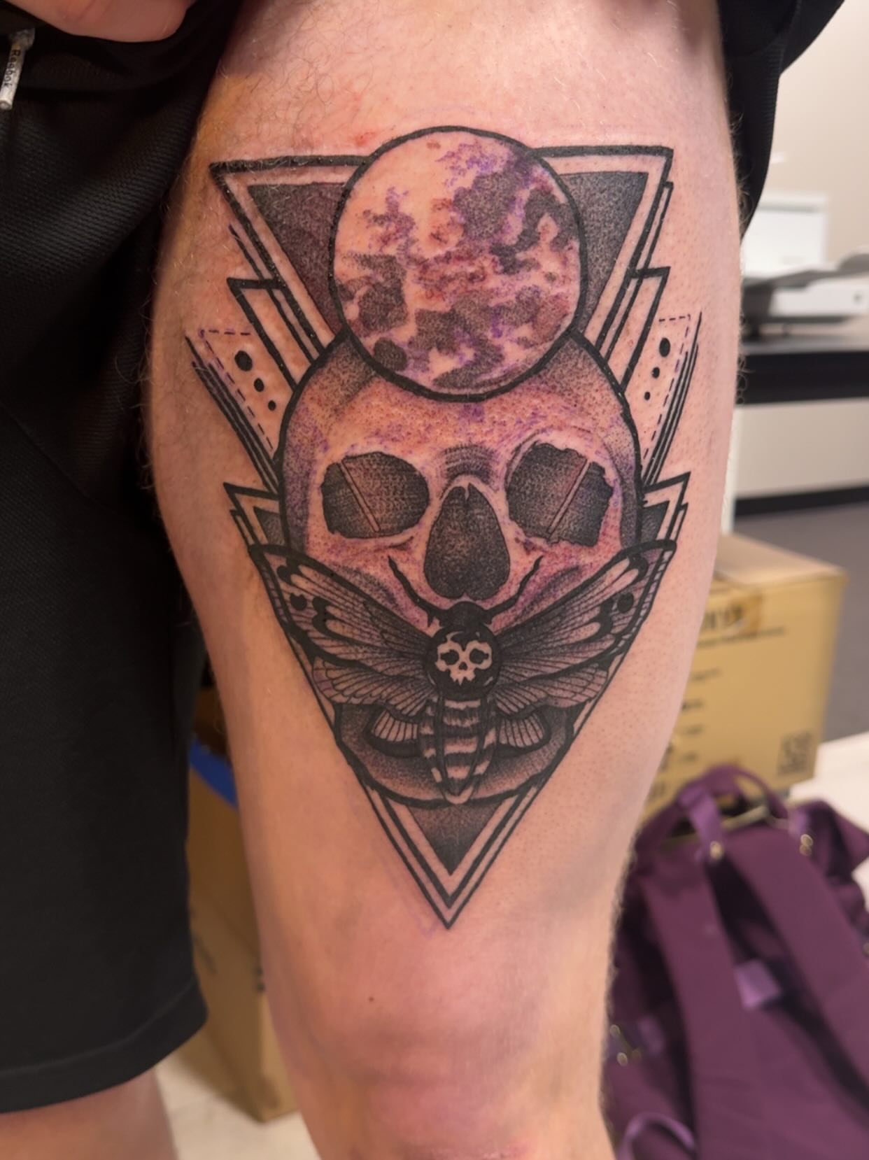 Skull and moth geometric tattoo on the thigh by Lindsay