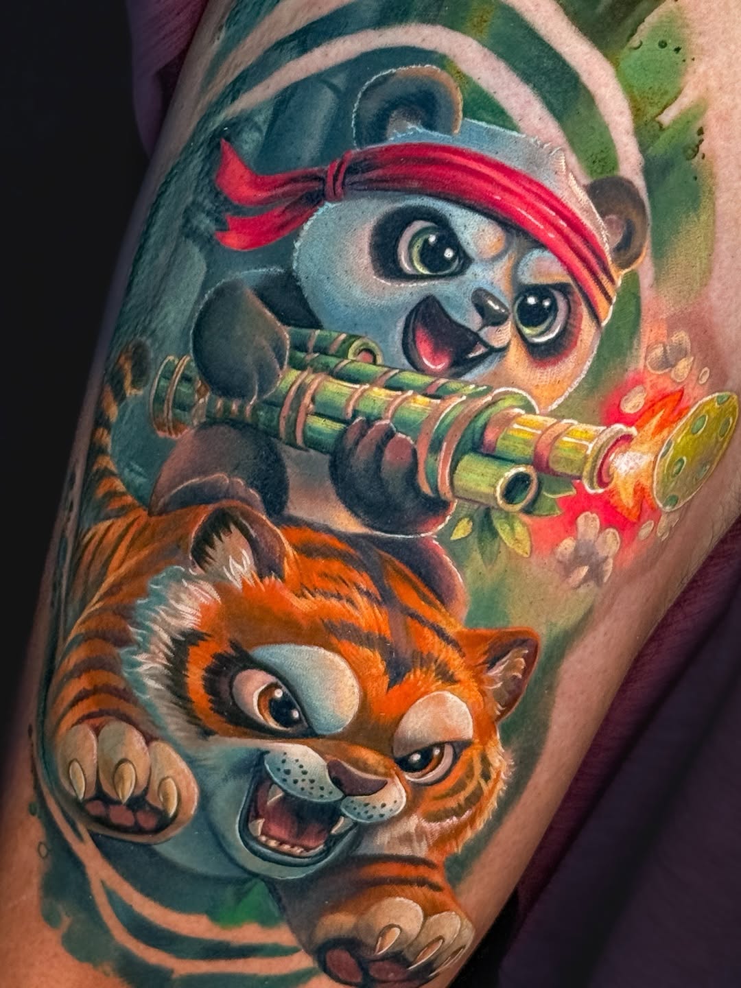 Panda and tiger characters realism tattoo on the forearm by Amy Zager