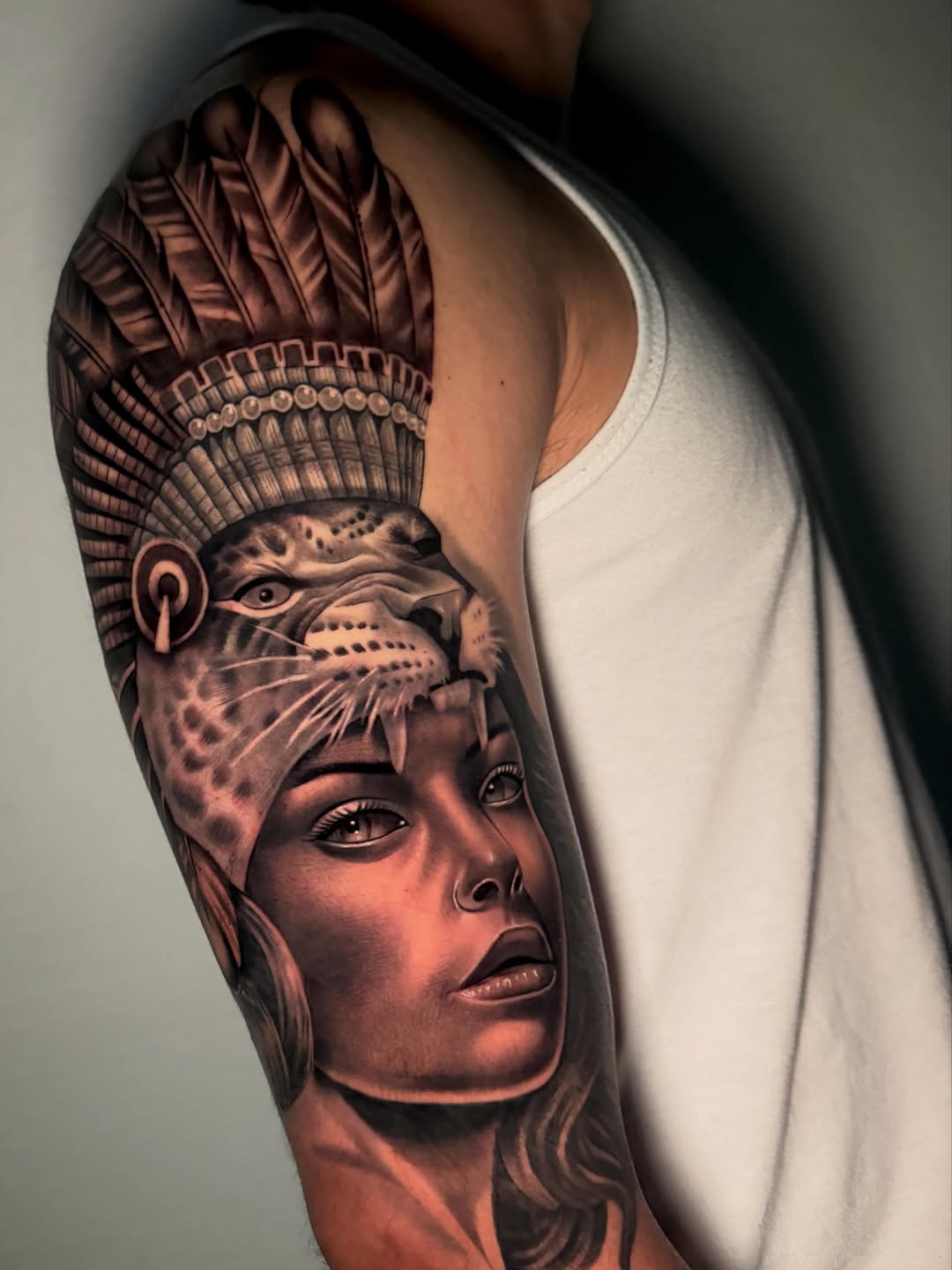 Woman with headdress and jaguar mask realism tattoo on the forearm by DH Tattooing