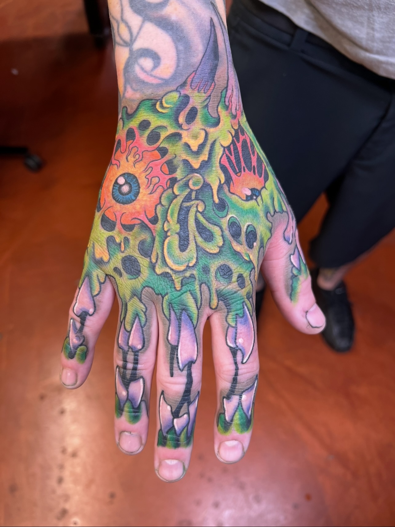 Abstract flame new school tattoo on the hand by Bobby Tobin