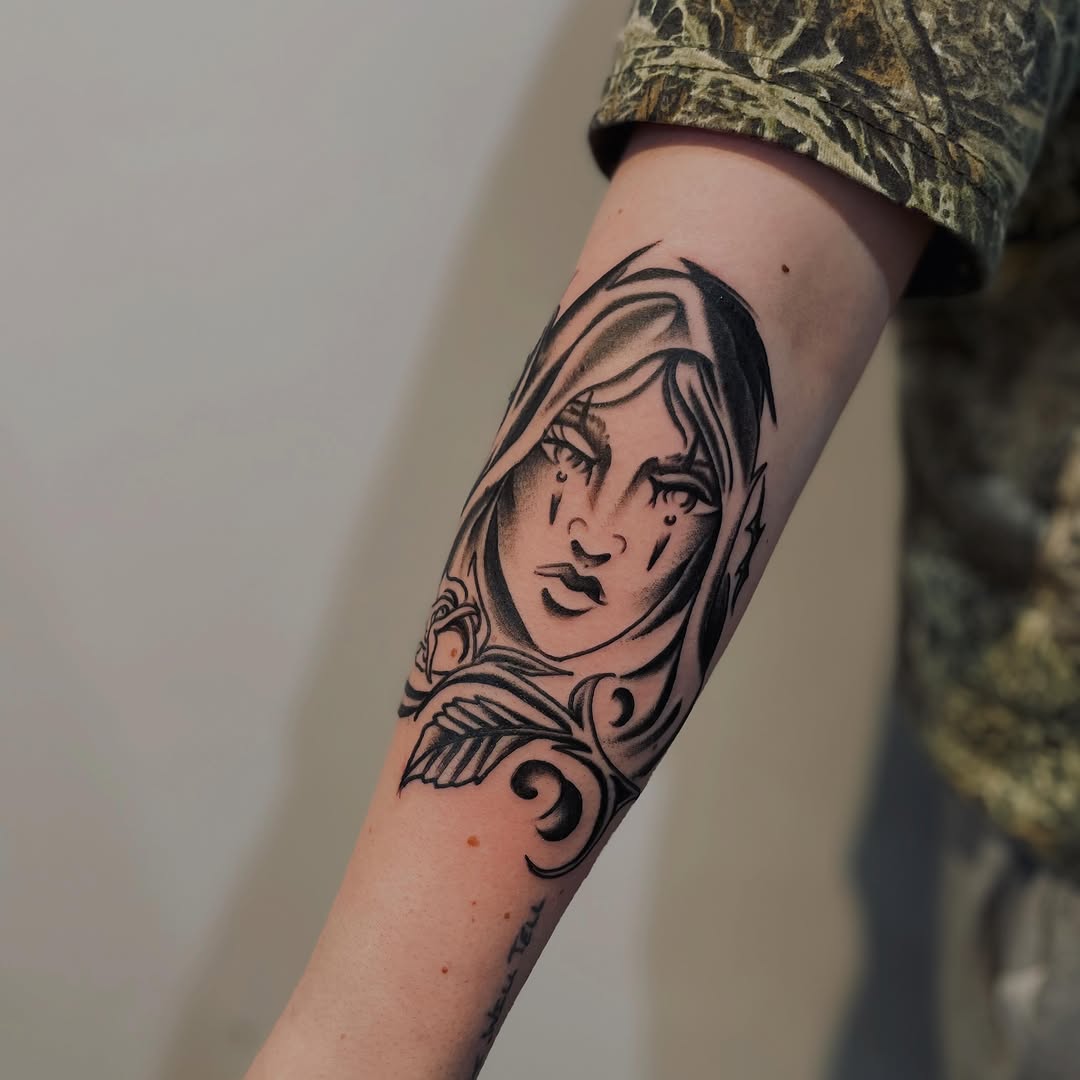 Woman's face with rose realism tattoo on the forearm by Christien Xavier Alba, Salt Lake City, Utah