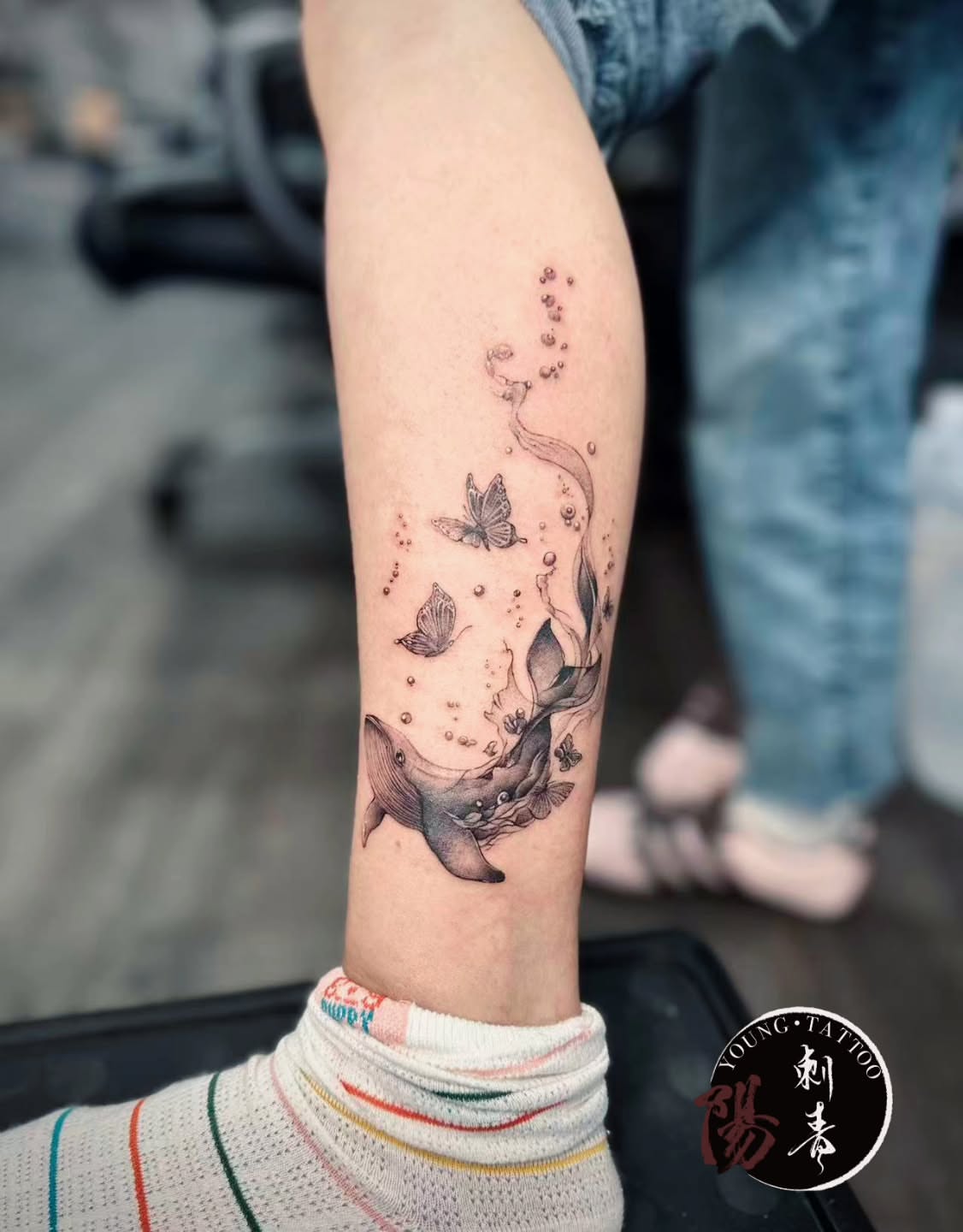 Whale and butterflies dotwork tattoo on the forearm by Ying