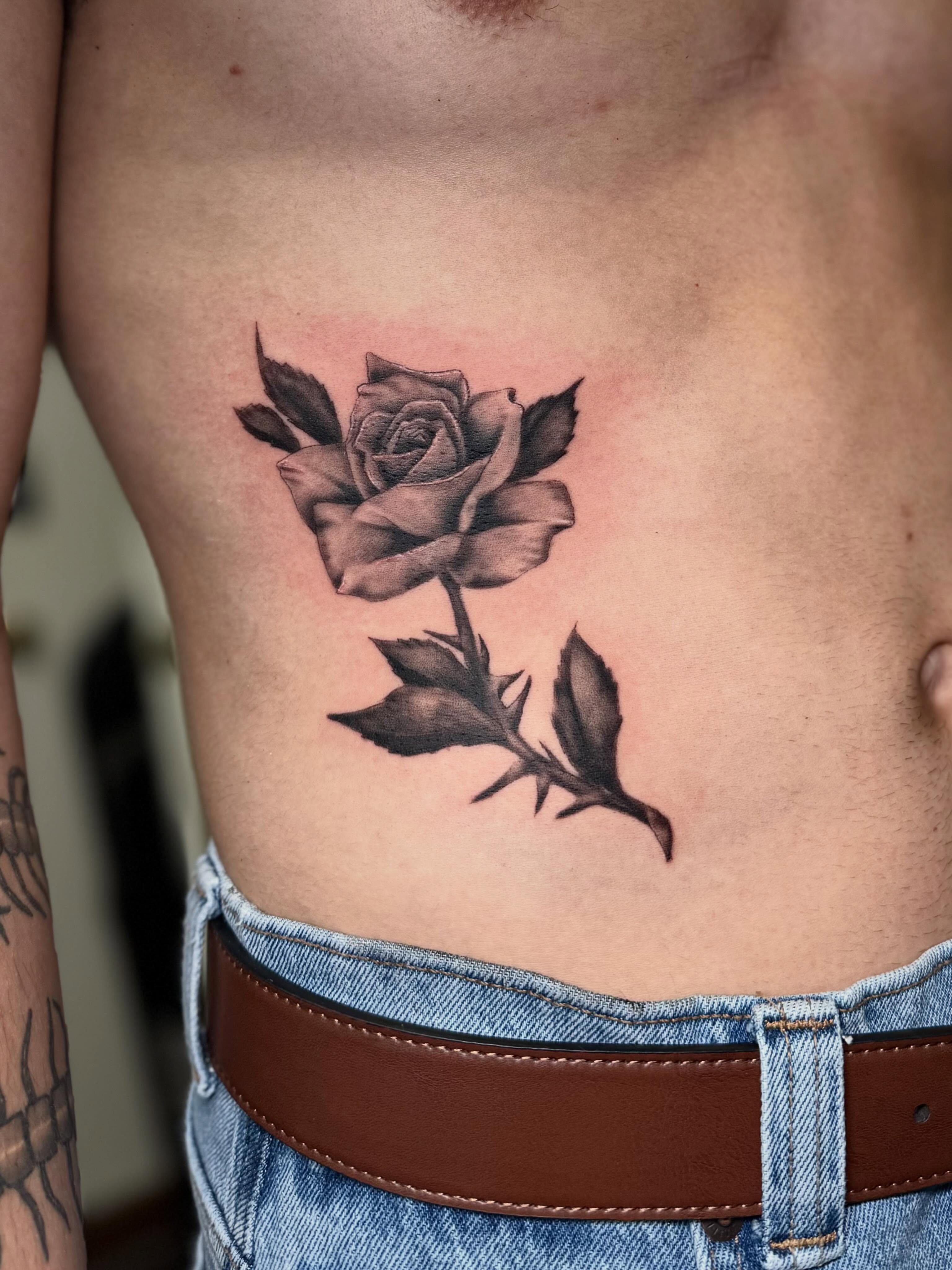 Rose black and grey tattoo on the ribs by βπ¬π―π’πΆ