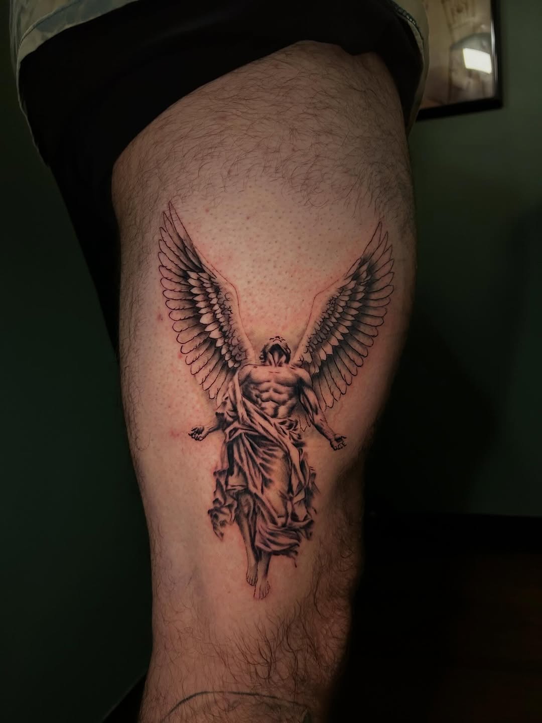 Angel realism tattoo on the thigh by Dylan Stevens